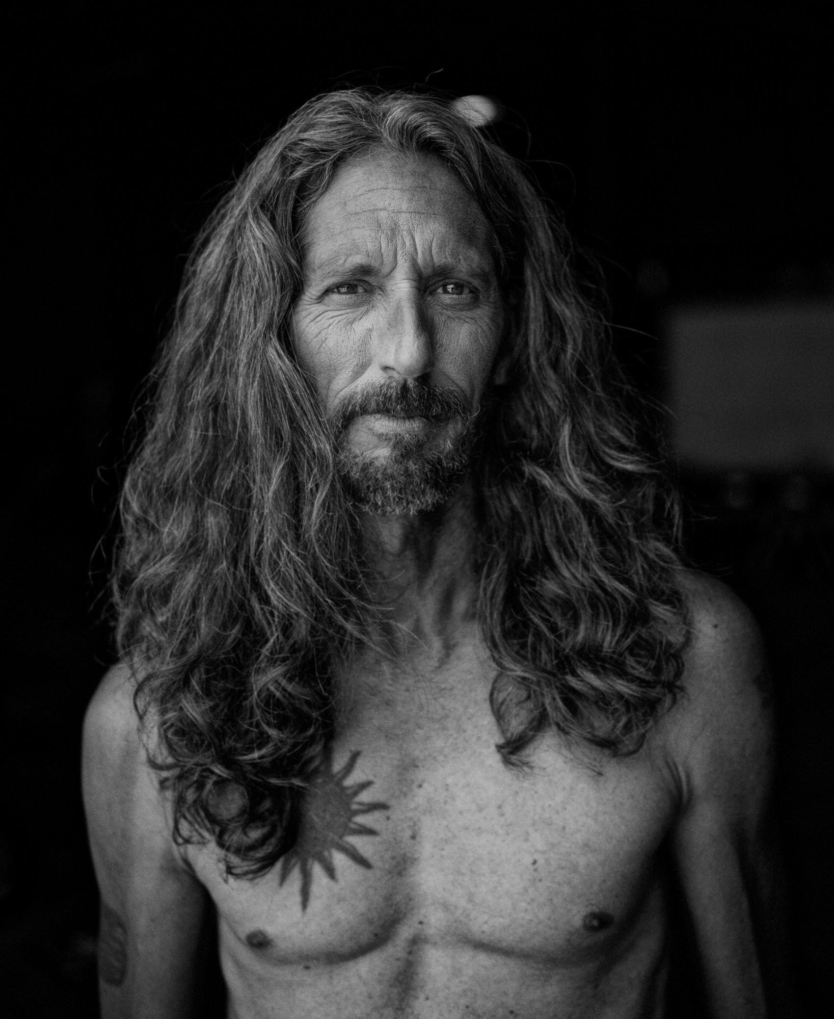 Black and White photo portrait of long hair man. Camera Hasselblad X2D.