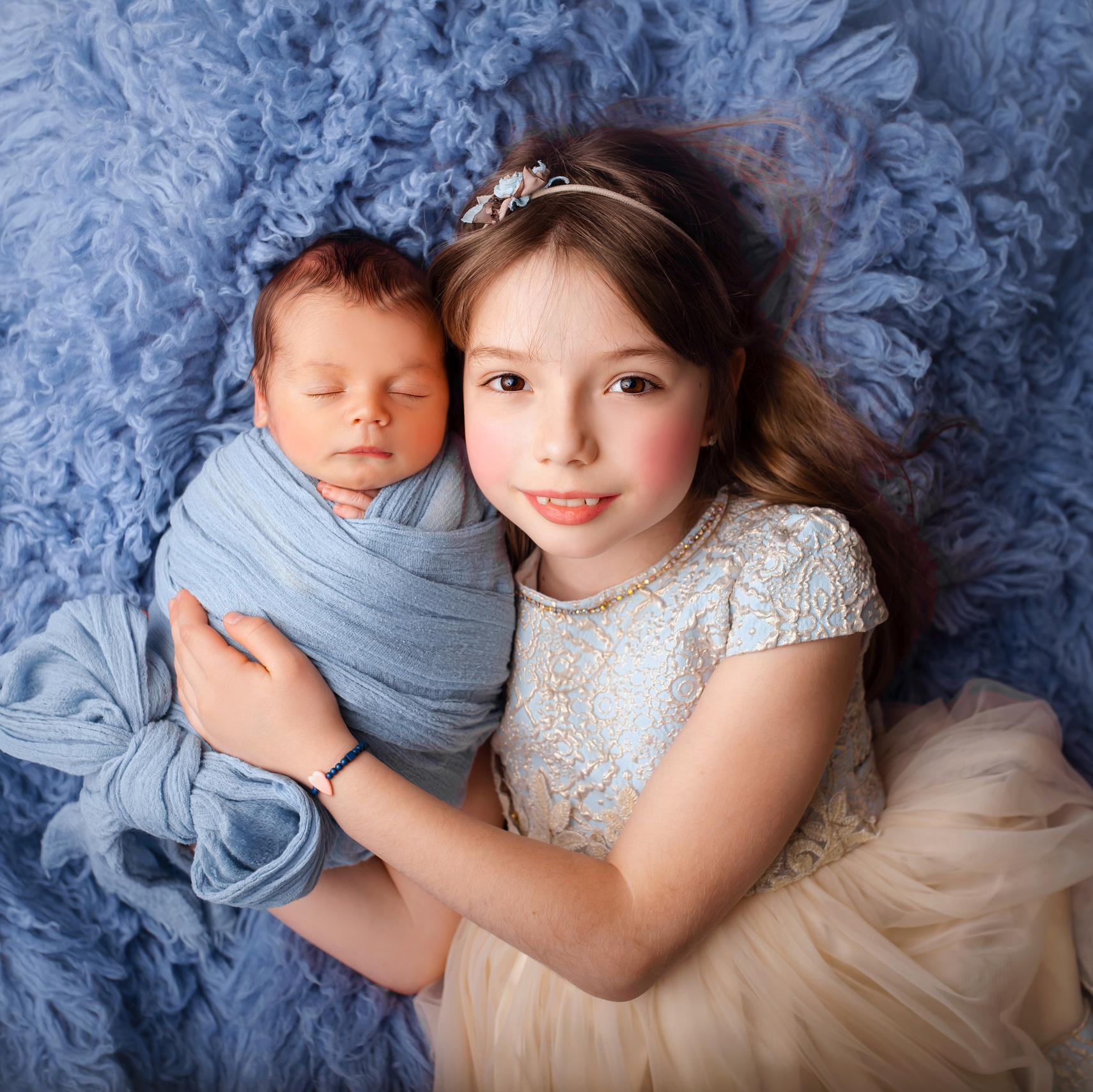 Newborn baby with older sister during a newborn photography session in Prague