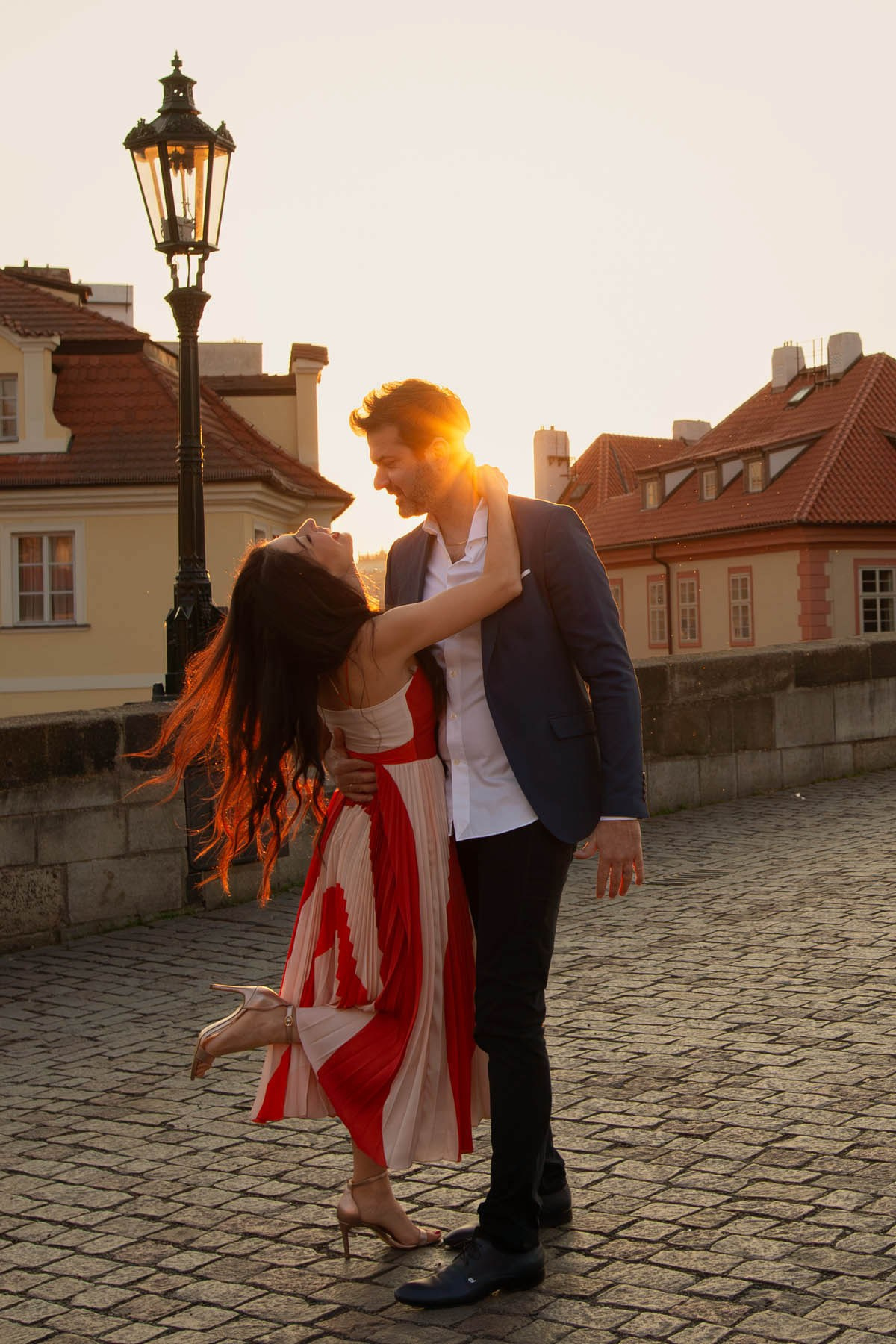 The gorgeous Italian couple, Dalila and Andrea, celebrate their wedding anniversary in the early-morning sunshine at Prague's Charles Bridge.