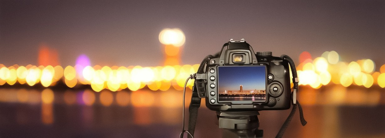 Close-up of a camera on a blurred background, capturing the essence of photography