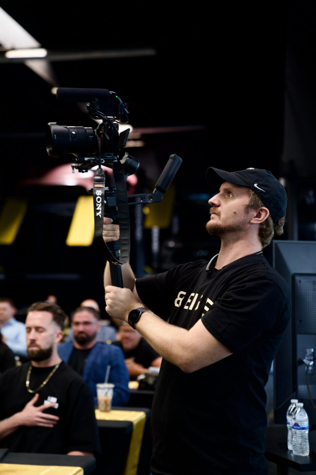 Camera operator filming a business event for a professional live broadcast