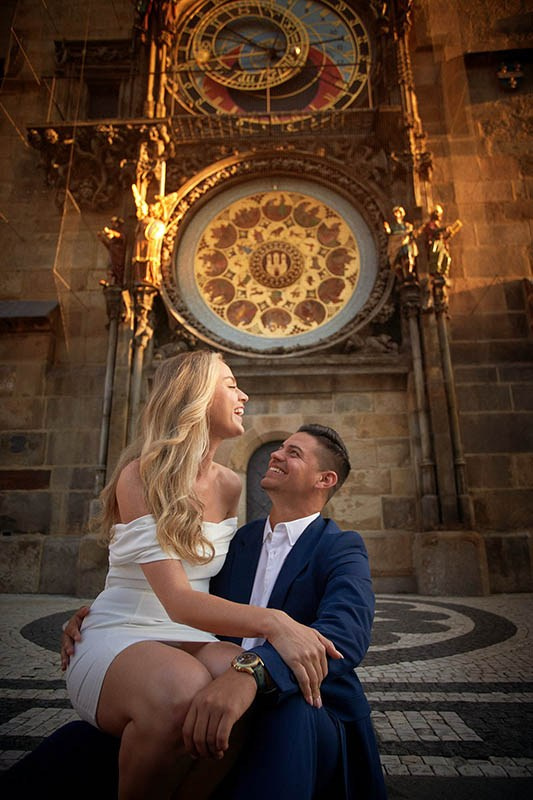 A gorgeous couple lovingly embraces as the sun flares vibrantly between their faces.