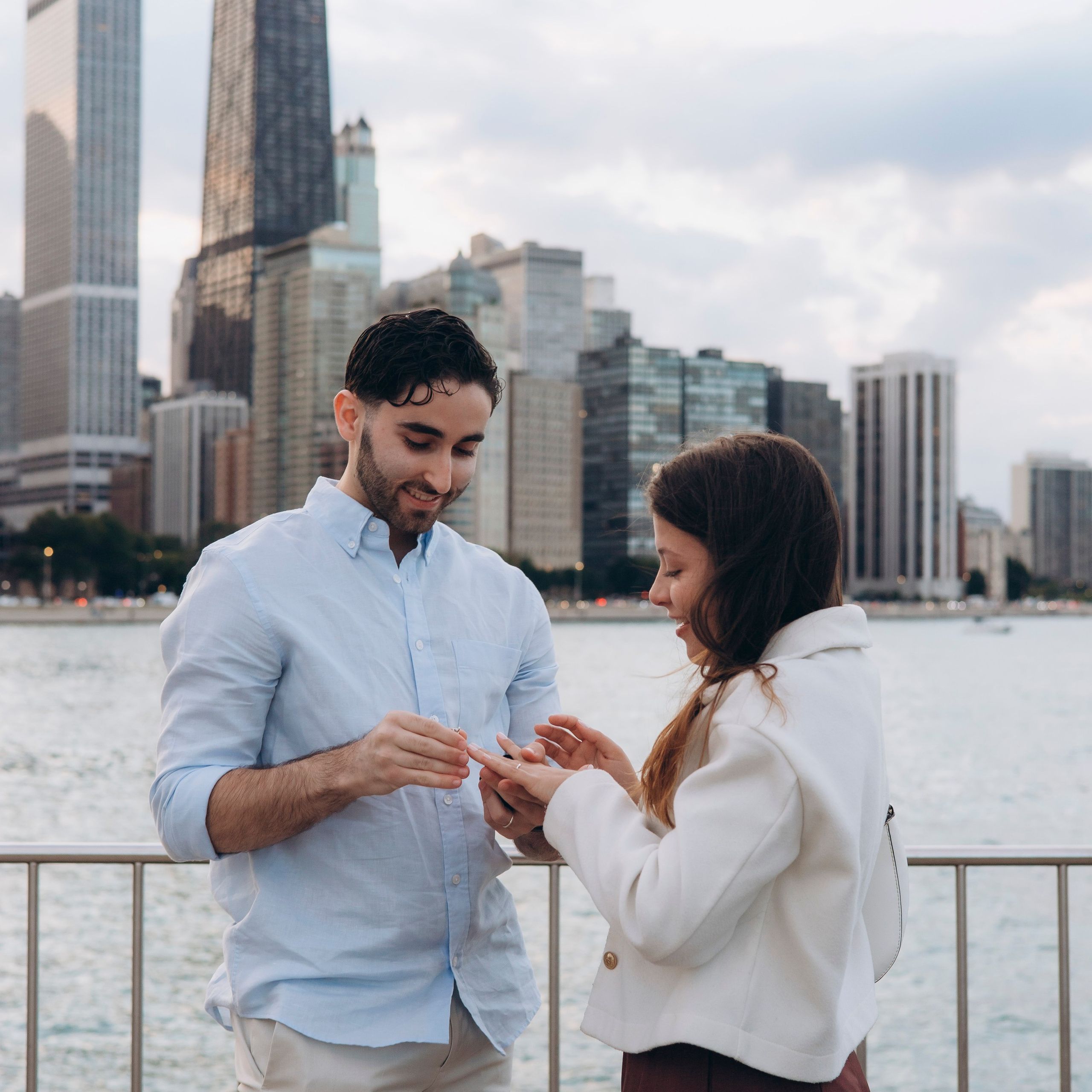 Couple laughing during an engagement session at Milton Lee Olive Park in Chicago.