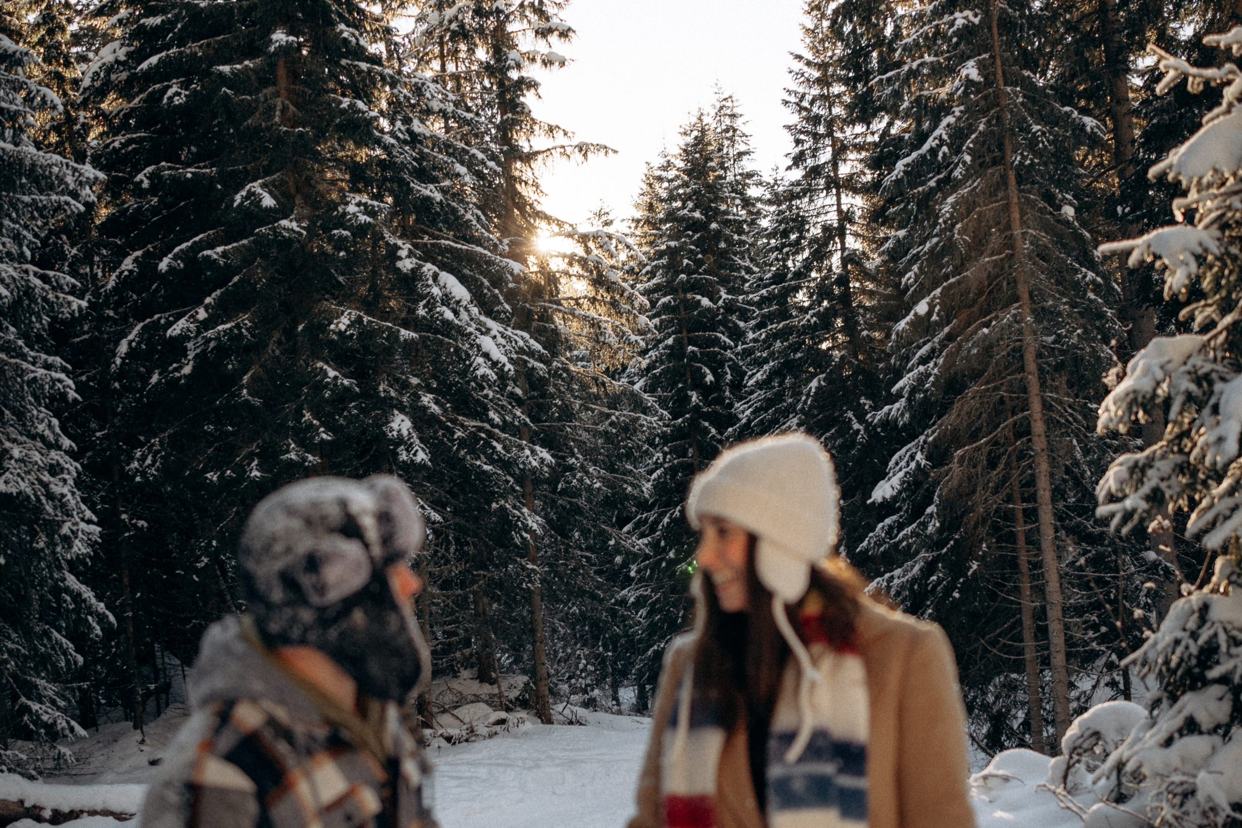 Candid moment of couple hugging in snowy Dolomites winter landscape