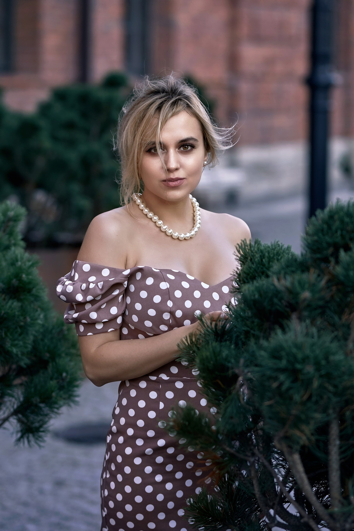 Beautiful woman in a summer dress during an outdoor photo session in a garden – on-site photo shoot in NJ