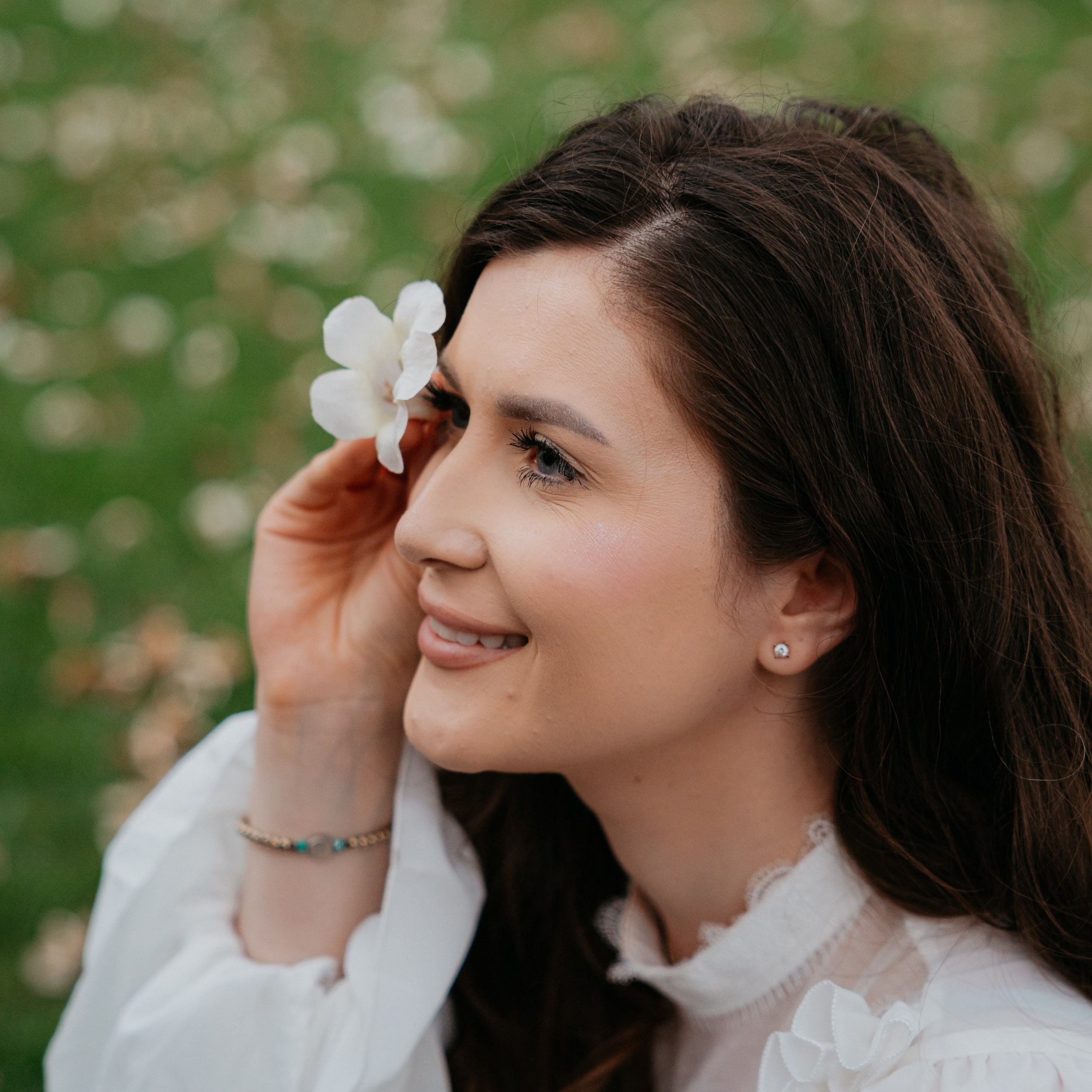 Portrait of a woman in a white dress outdoors
