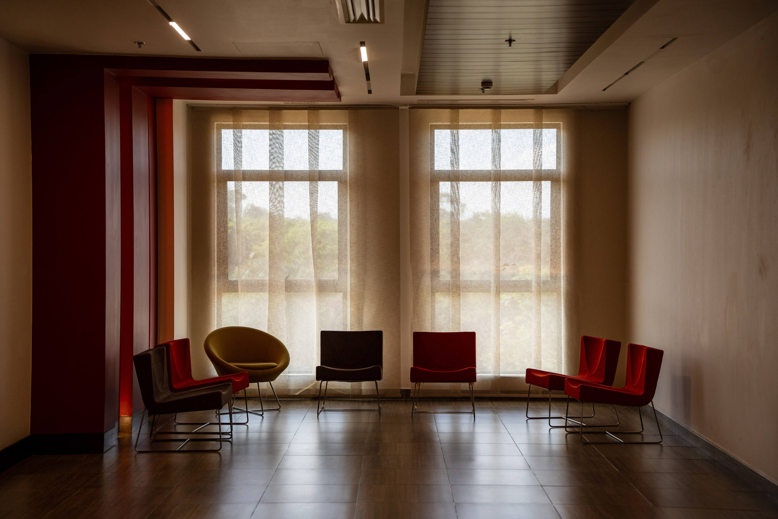 A cinematic photo of a reception with empty seats, a big window at the back, symbolizing my 'Contact me' page