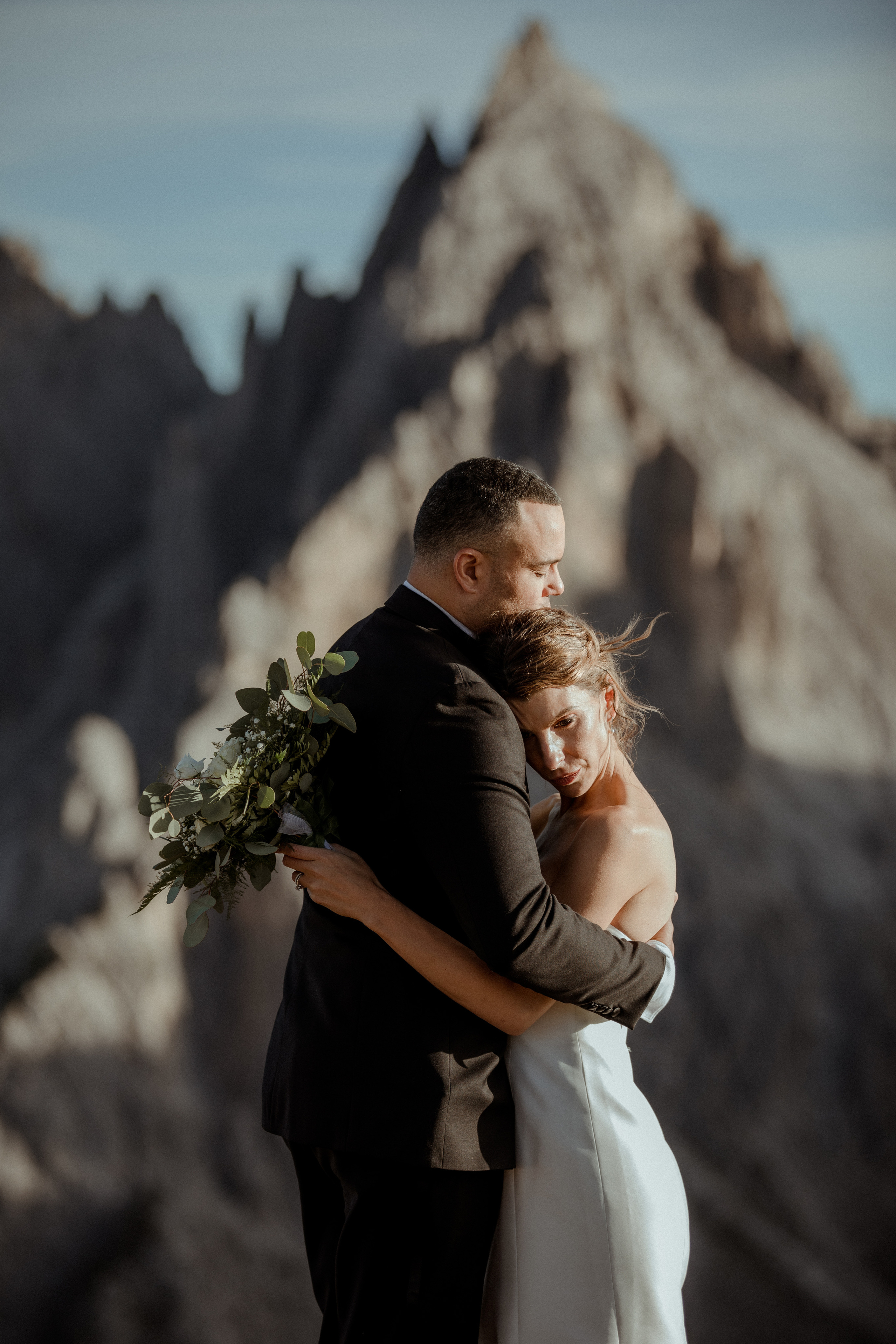A couple with a rocky landscape in the background