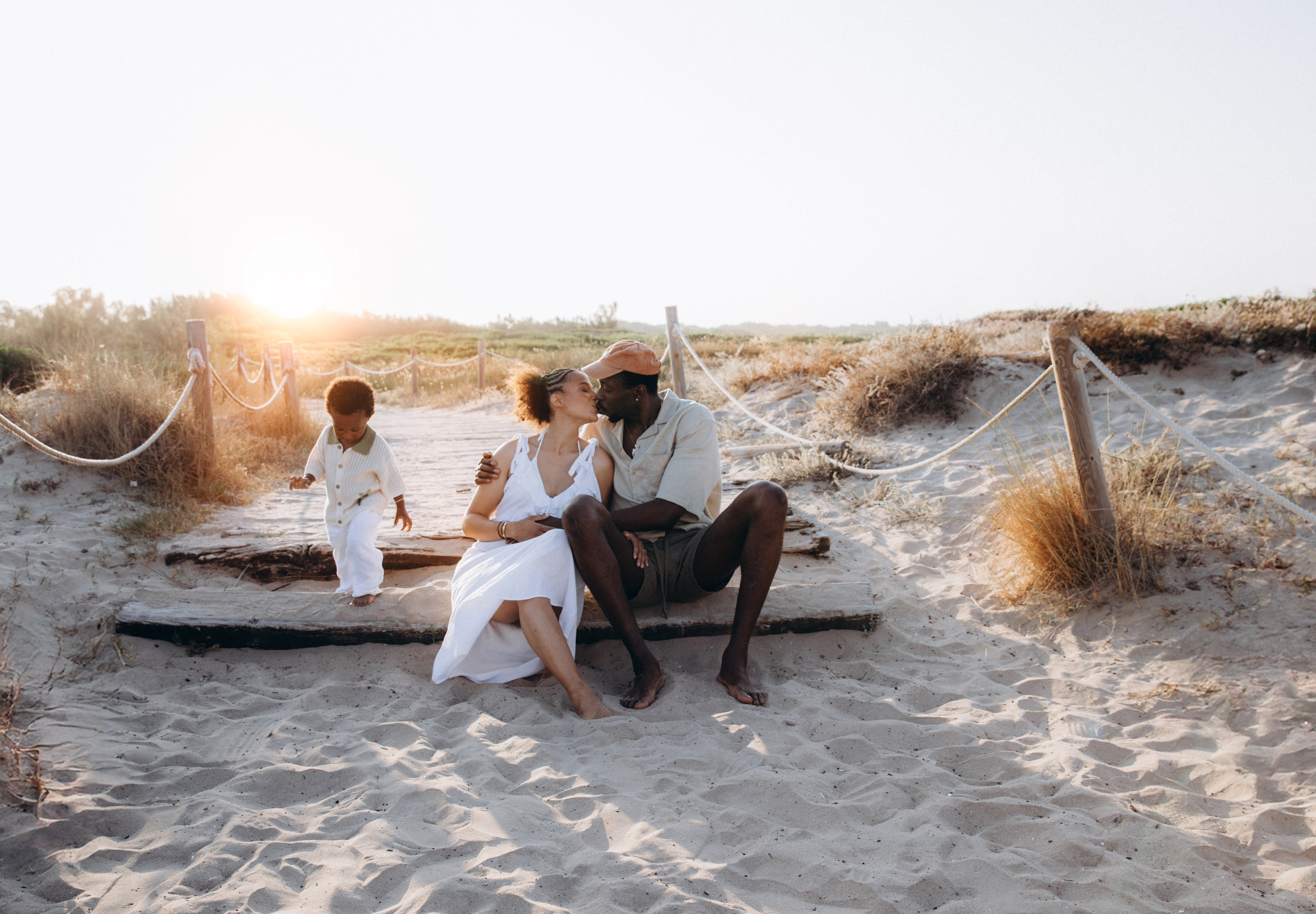 Family photoshoot in Valencia, Spain, showing parents and children sitting together in a natural outdoor setting, photographed in warm natural light with a relaxed atmosphere, illustrating what a calm and unposed family photoshoot experience in Valencia looks like.