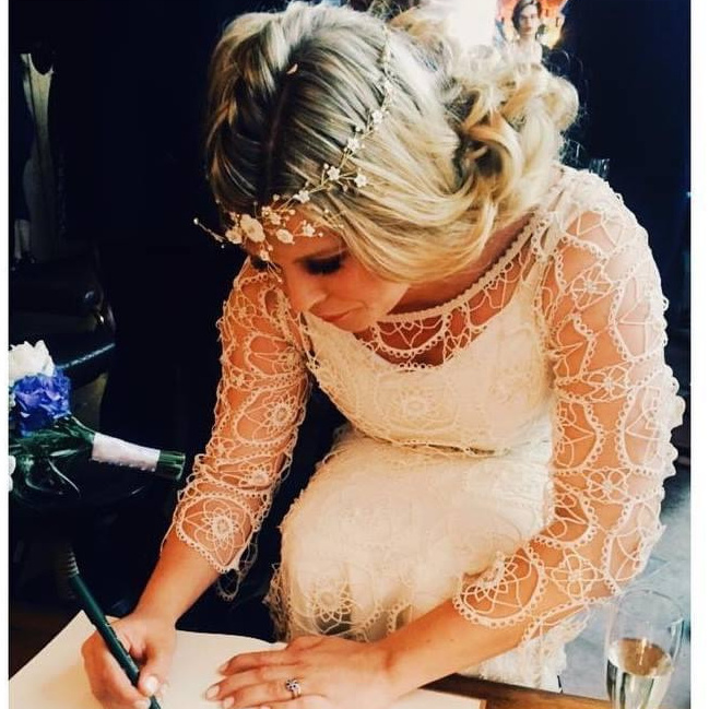 A lifestyle portrait of a bride signing the official document during her wedding ceremony in London. Destination Wedding