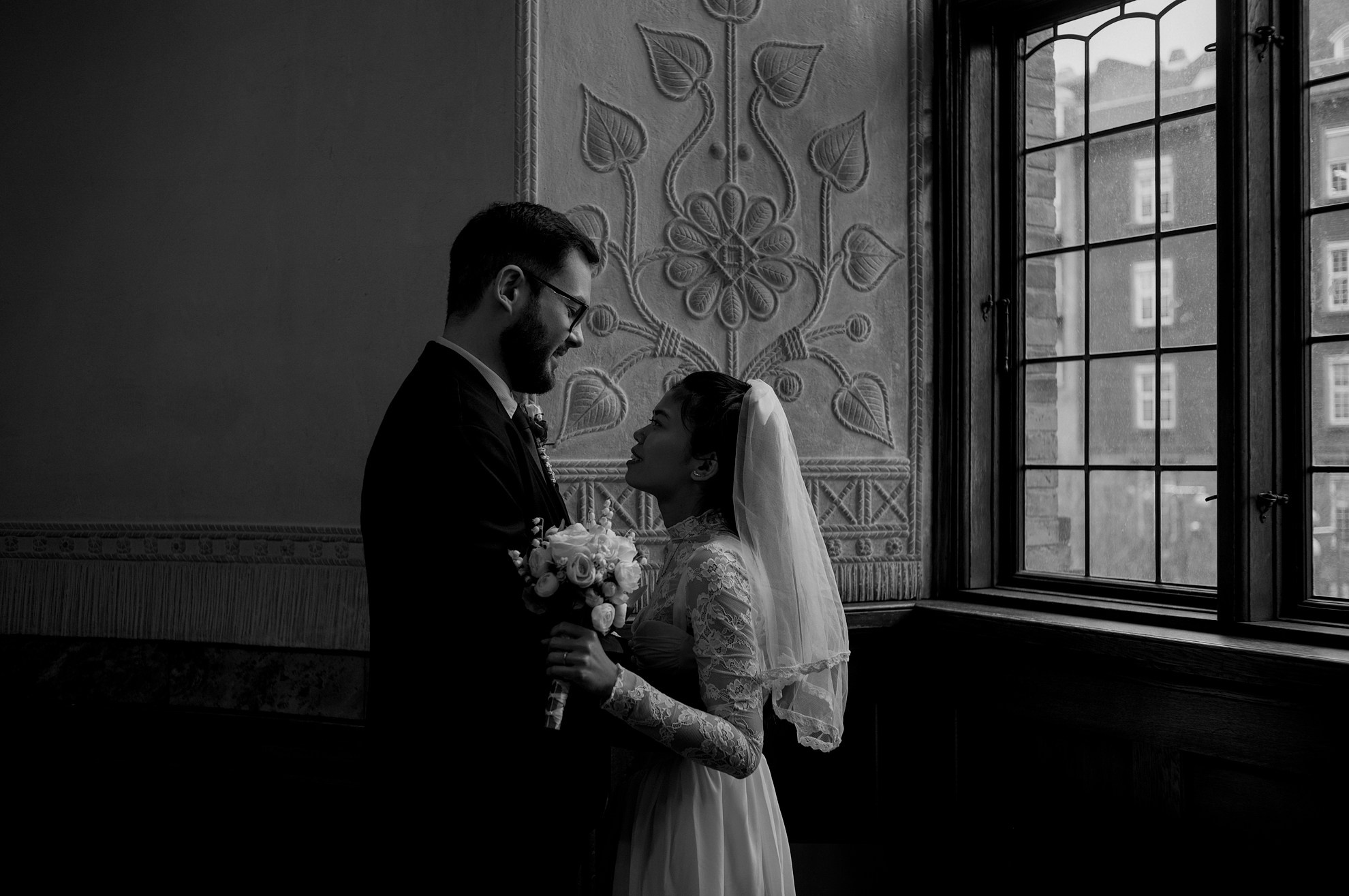 Bride and groom sharing a quiet moment inside Copenhagen City Hall