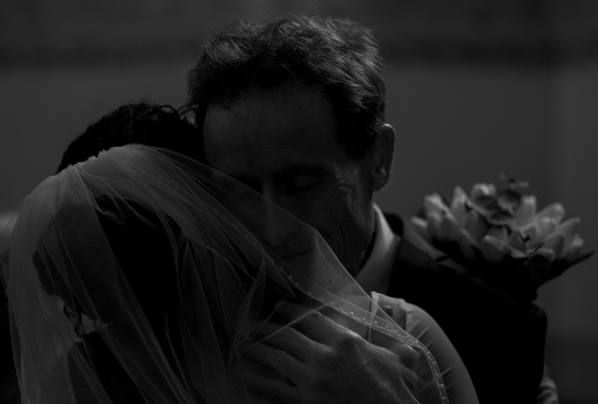 Emotional moment as the groom’s father embraces the bride