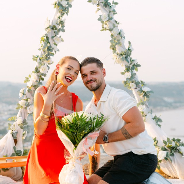Engagement in Rhodes 💍 engaged couple sitting after the proposal at Profitis Ilias near Faliraki overlooking the Aegean Sea in Greece.