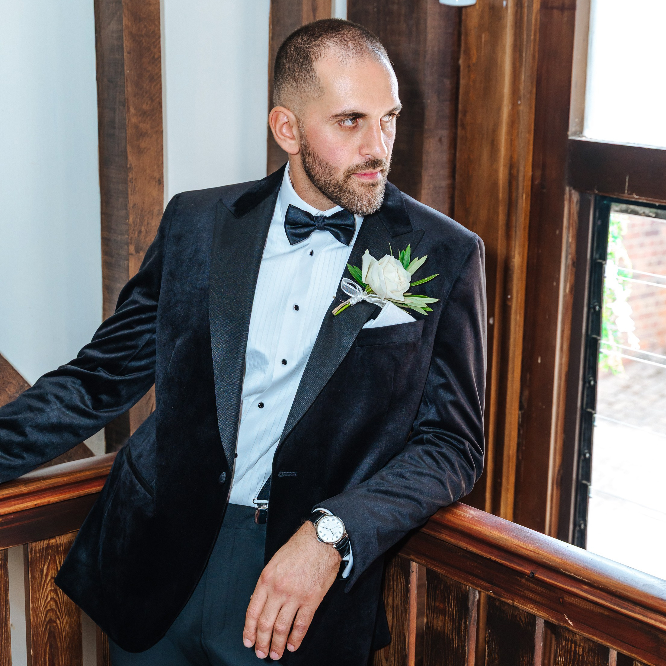 the groom getting ready by the window, natural light wedding photography England