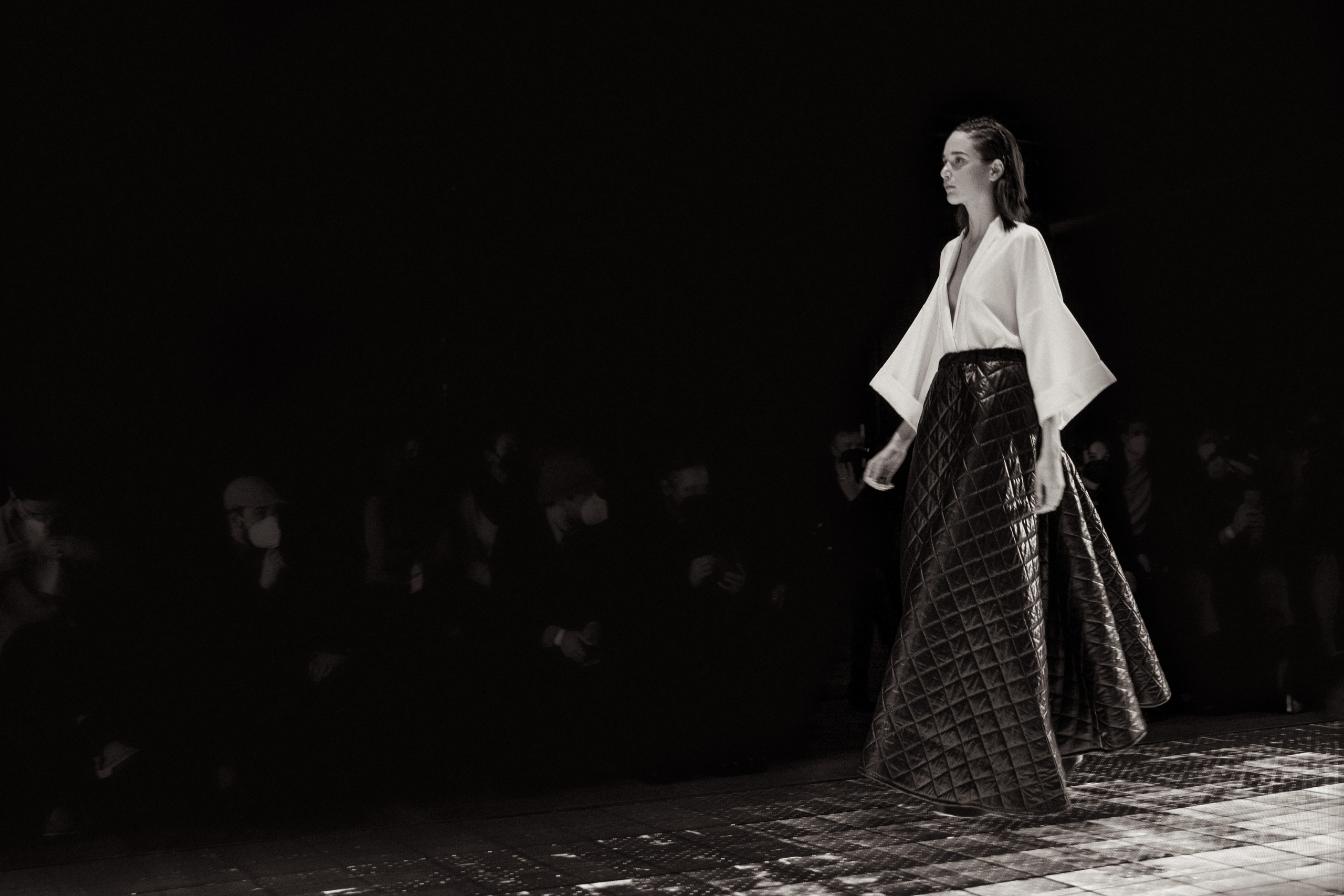 A model posing in a bold designer piece at Rome Fashion Week, captured by photographer Elizaveta Razumova.