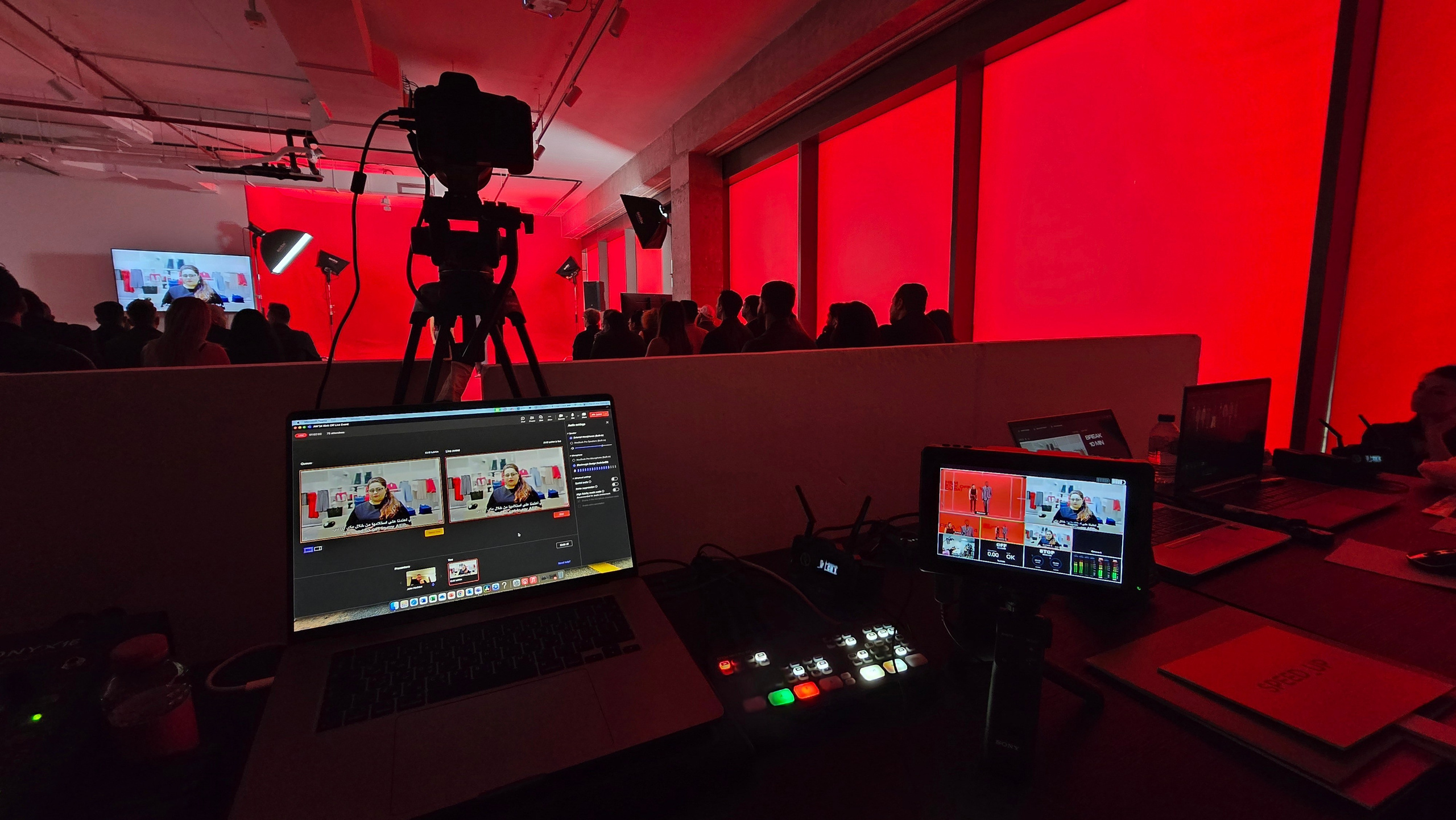 Professional live streaming setup with a camera, video switcher and production monitors at a corporate event