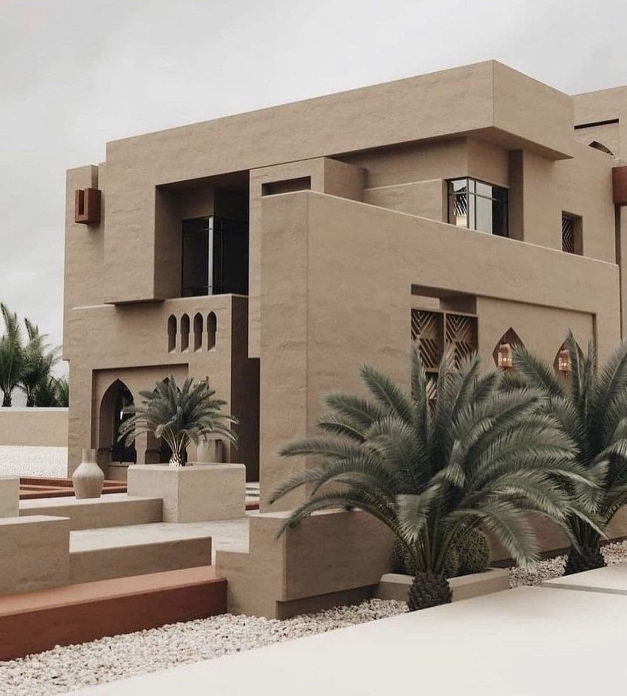 Modern desert villa with beige facade and palm trees