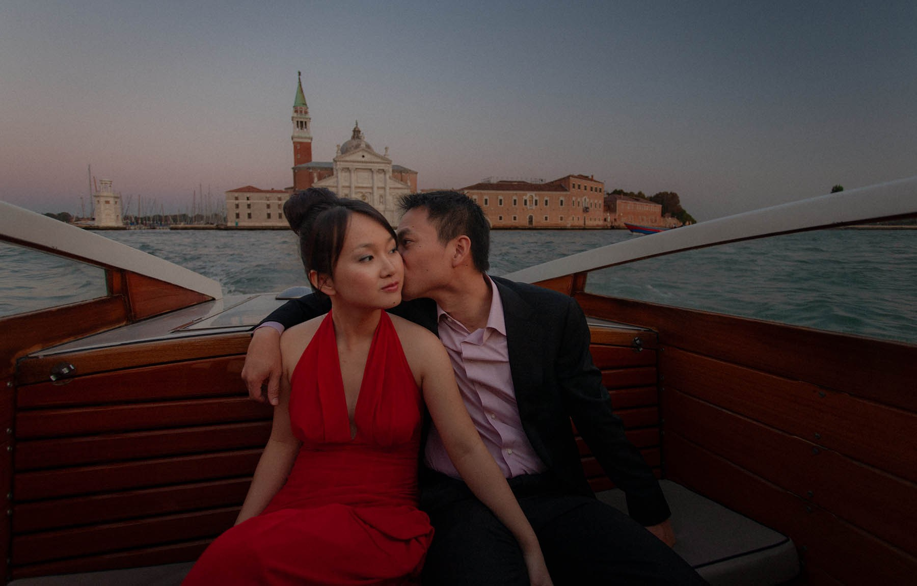 A Thai couple relaxes in the quiet solitude of their private charter as they return from the island of San Giorgio Maggiore in Venice.