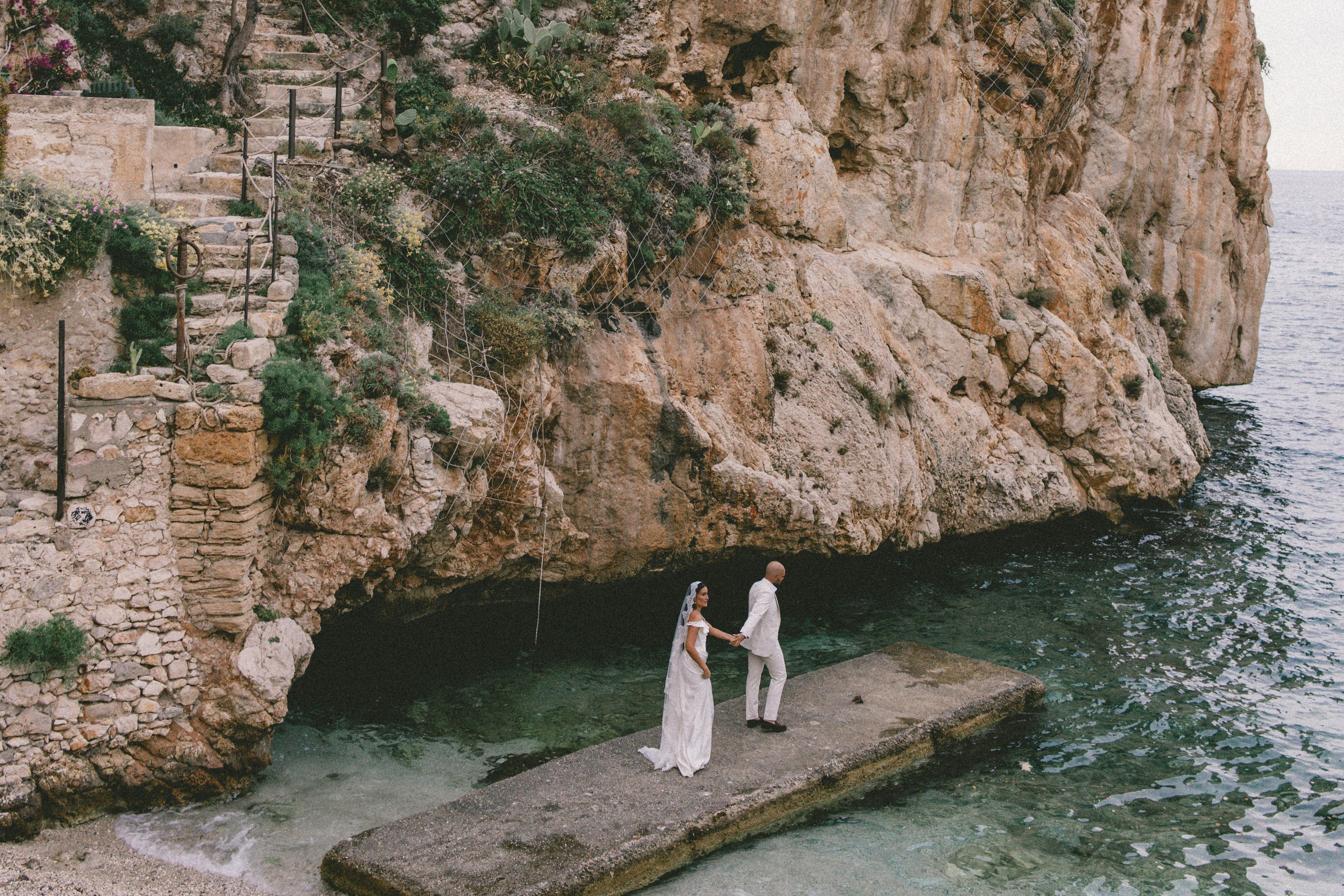 Couple exchanging vows on a terrace overlooking the sparkling Amalfi Coast.