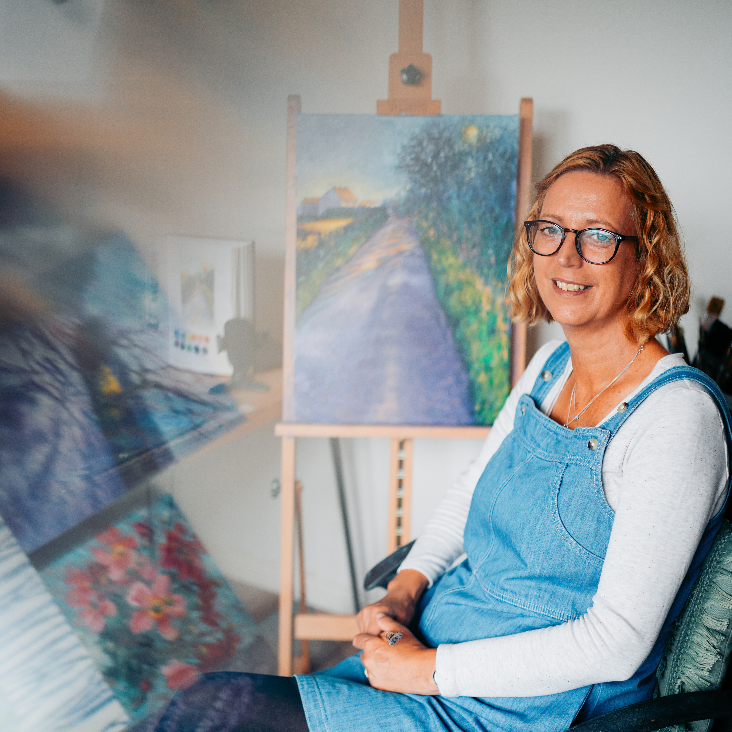 Artist at her home doing oil painting. Solihull brand photography for Pauline Pastel. Brand photographer in Birmingham. Brand photography Solihull.