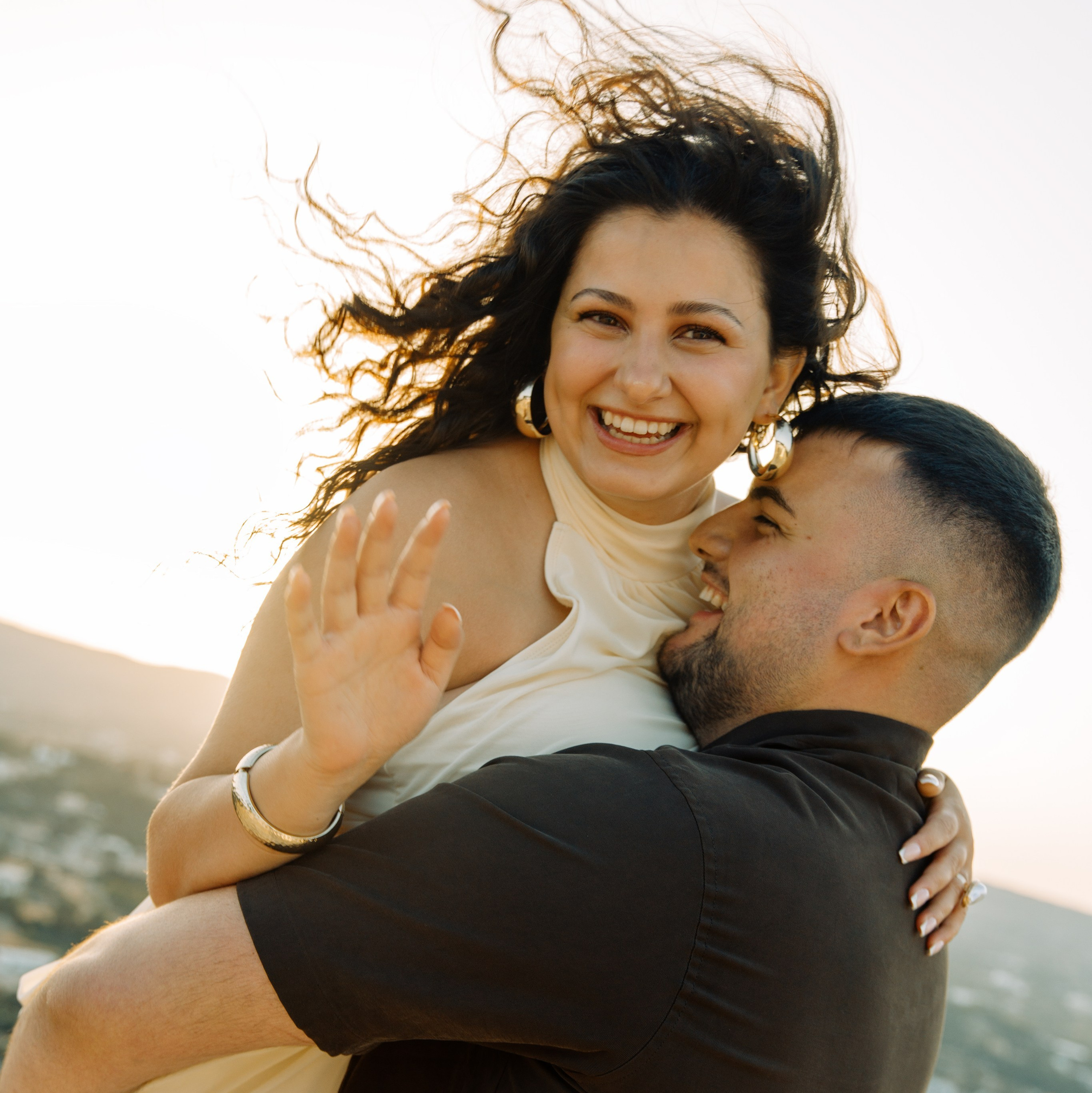 Engagement in Rhodes 💍 engaged couple sitting after the proposal at Profitis Ilias near Faliraki overlooking the Aegean Sea in Greece.