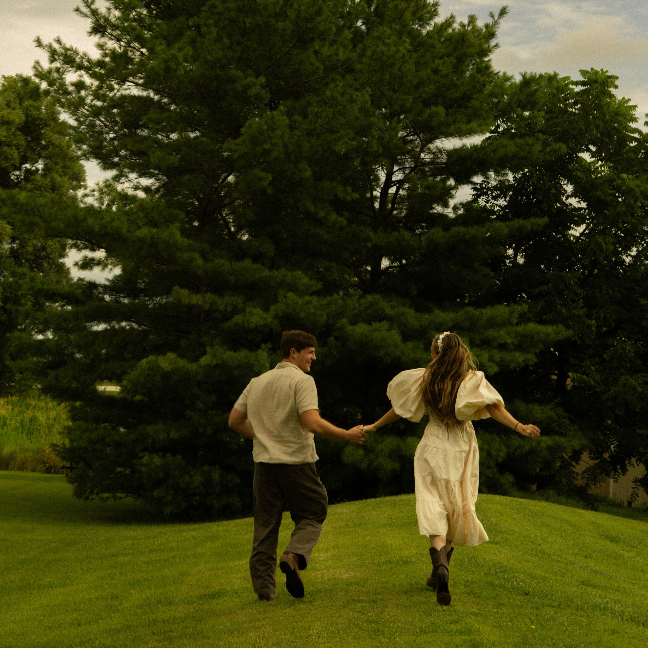 Oshkosh, WI bride and groom running of into nature.