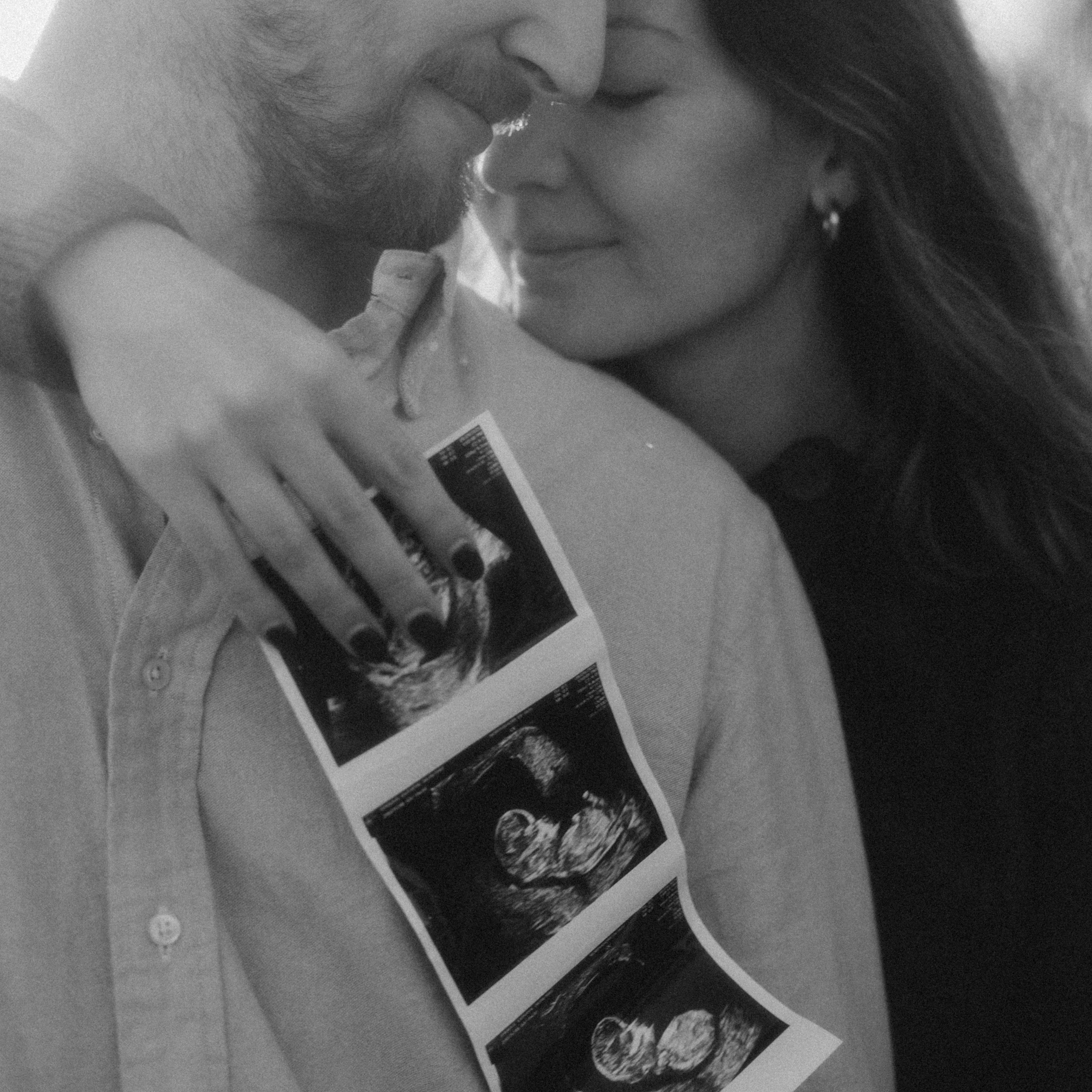 Emotional maternity portrait showing an expectant mother in soft, glowing light.