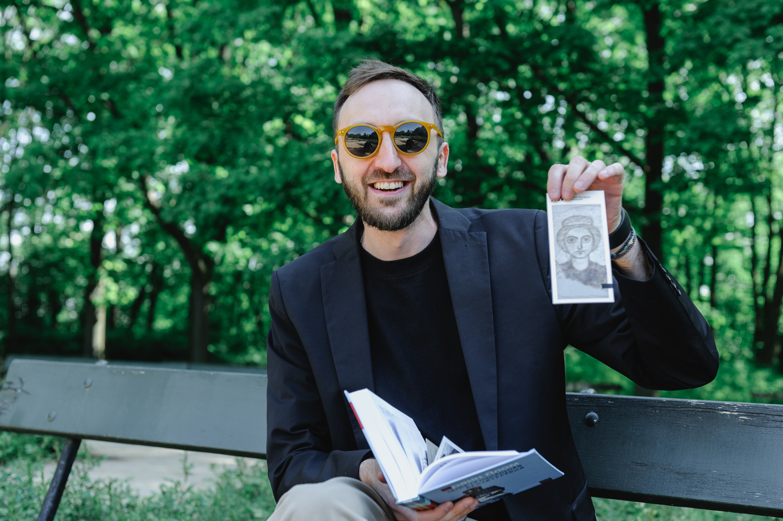 Cultural scholar Dmitry Solodkiy shows his bookmark for books.