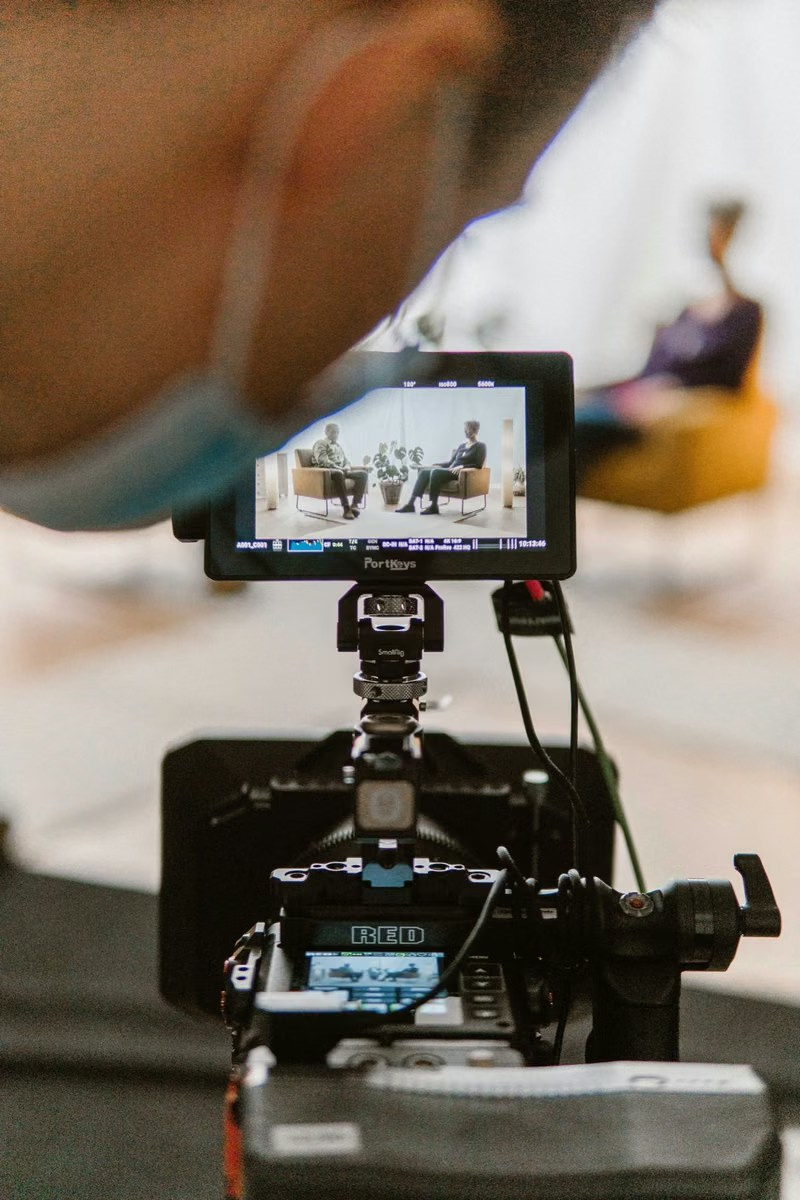 Camera operator recording an executive interview with professional video equipment