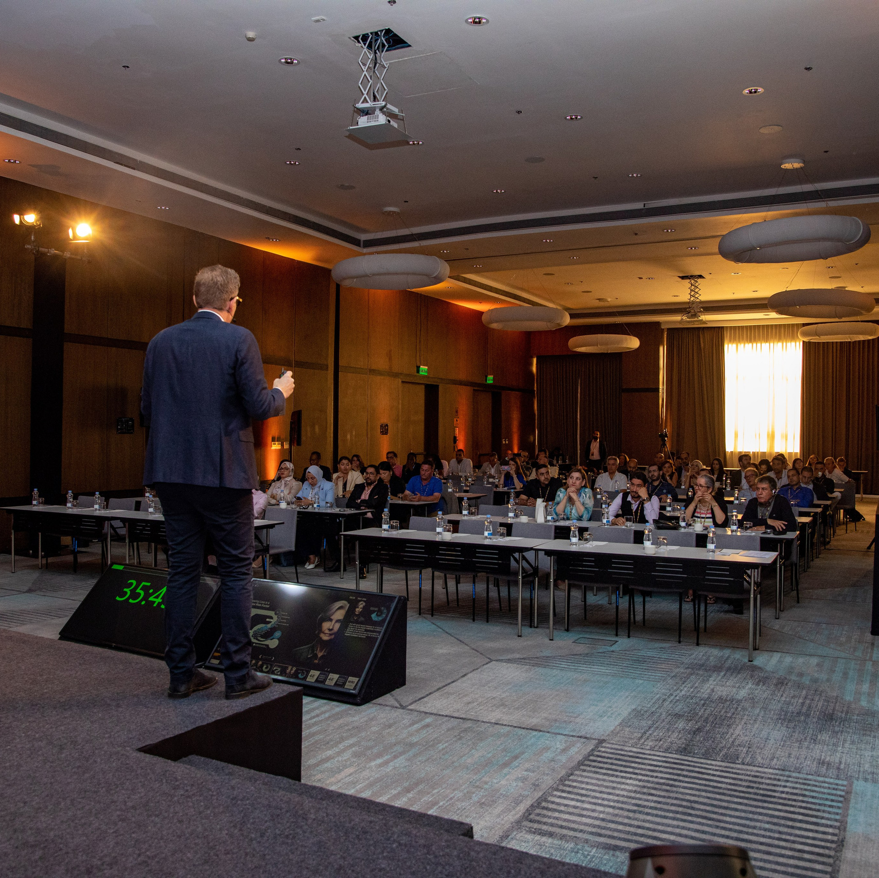 A photo of a conference room where a white man is addressing attendees from a podium, in Nairobi, Kenya