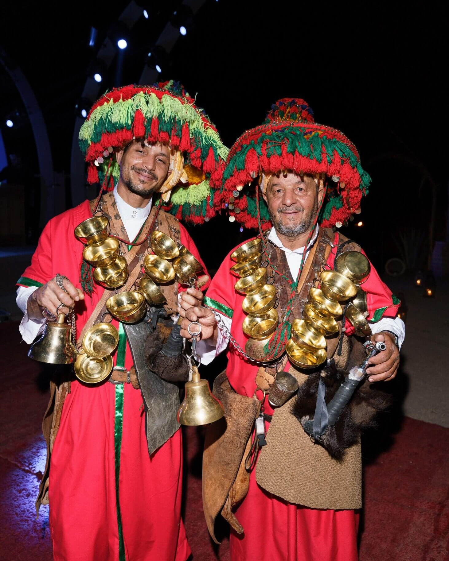 Traditional Moroccan performers in colourful costumes entertaining guests at a luxury wedding in Marrakech