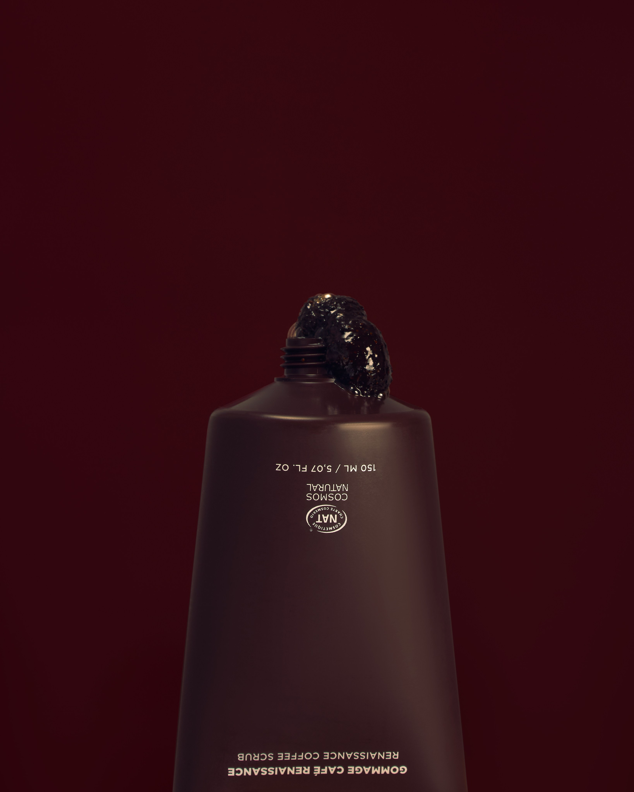 Body scrub tube with a small amount of scrub showing texture, modern advertising product photography, trendy lifestyle shot for social media and online shops“