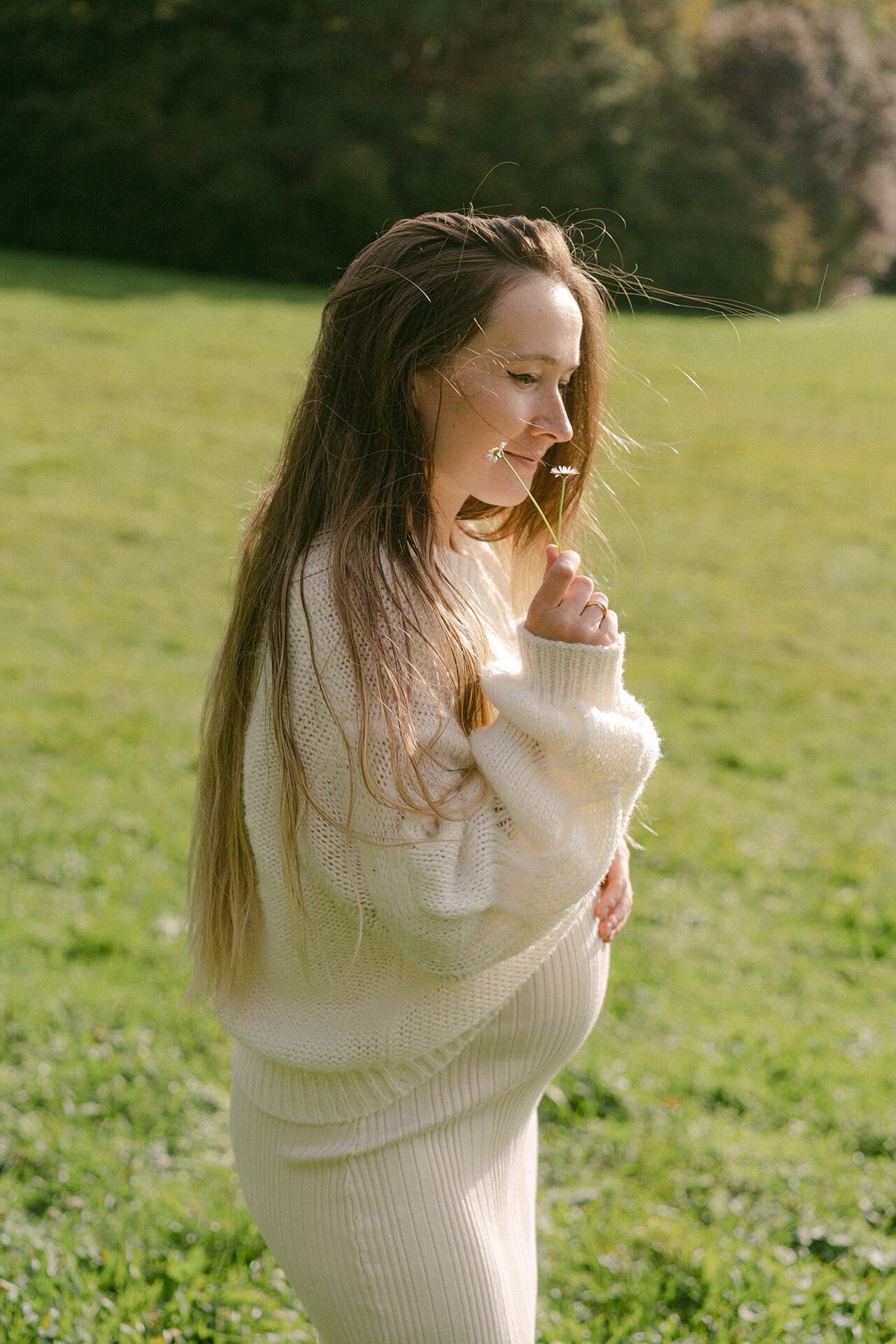 Mother and father in black tie classic outfits are holding their daughters during Christmas photo session