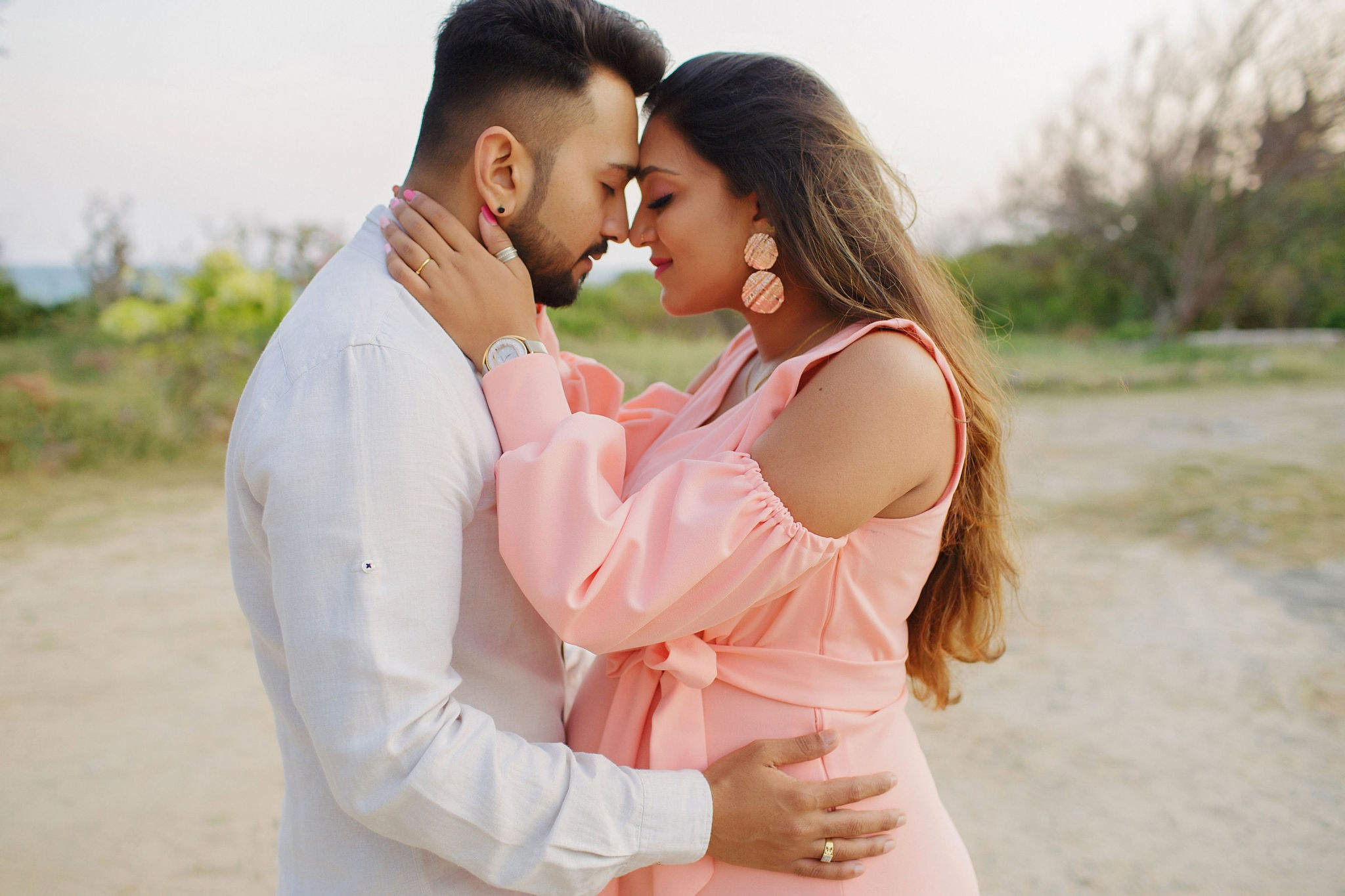 A peaceful family maternity portrait at golden hour, framed by coastal winds in Mombasa—timeless, natural, and full of heart.