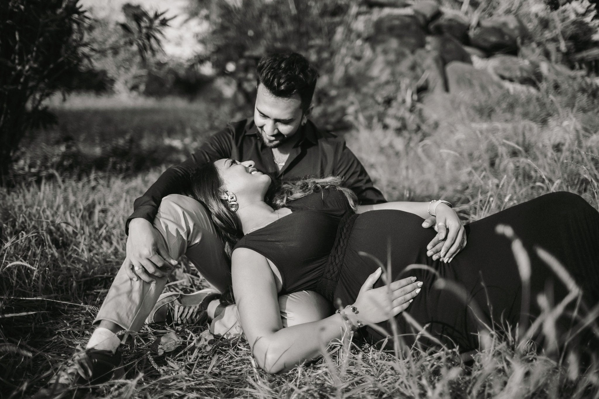 Couple laying on the grass during their timeless maternity session in Mombasa, Kenya.