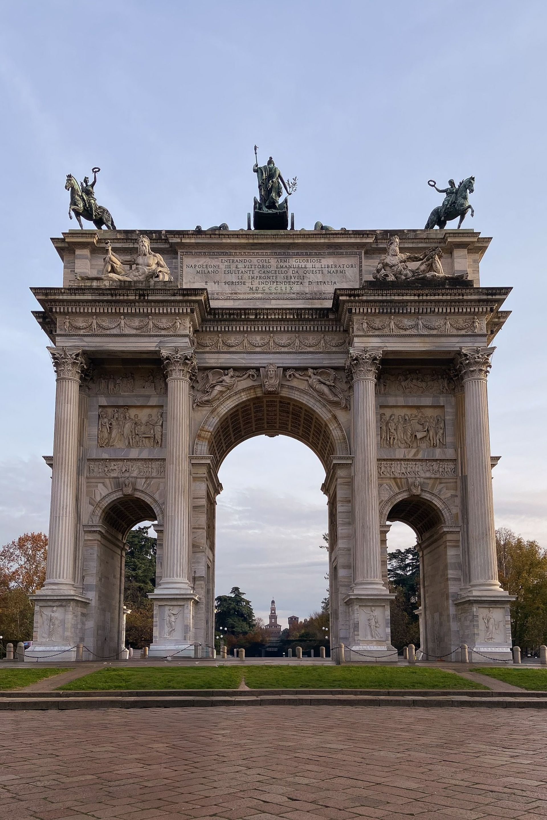 Arco della Pace at the end of a wide, open promenade