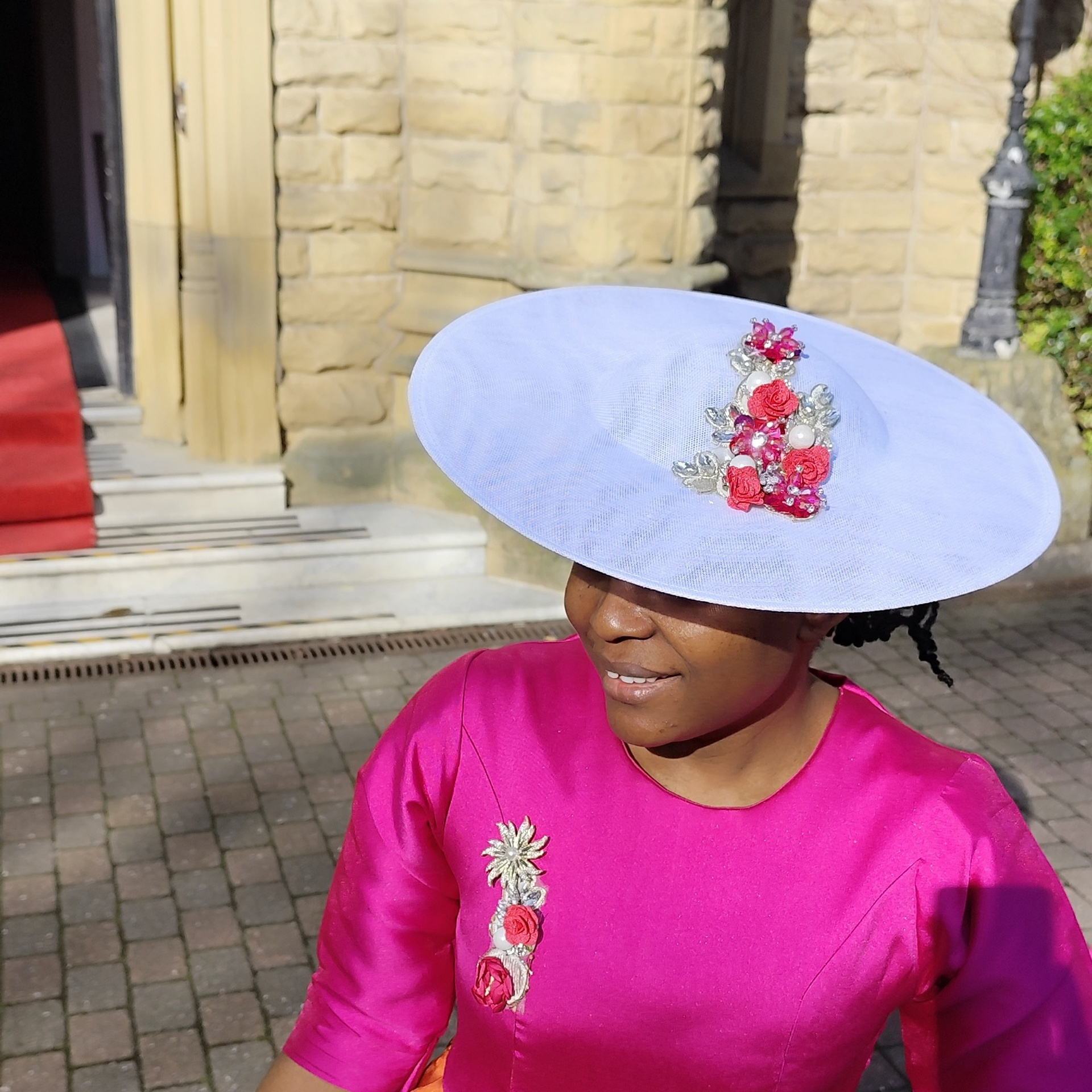 White hat with fushia pink applique for embellishment.