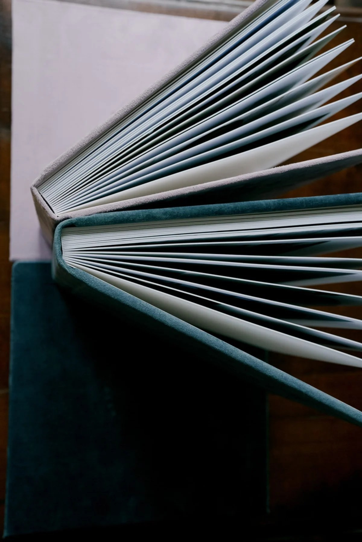 Open wedding album pages showing fine art printed photographs