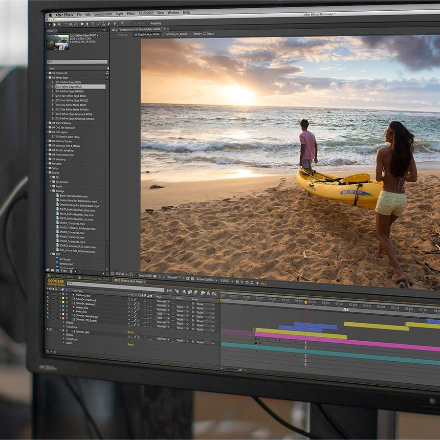 Man sitting and looking at a computer screen while video editing