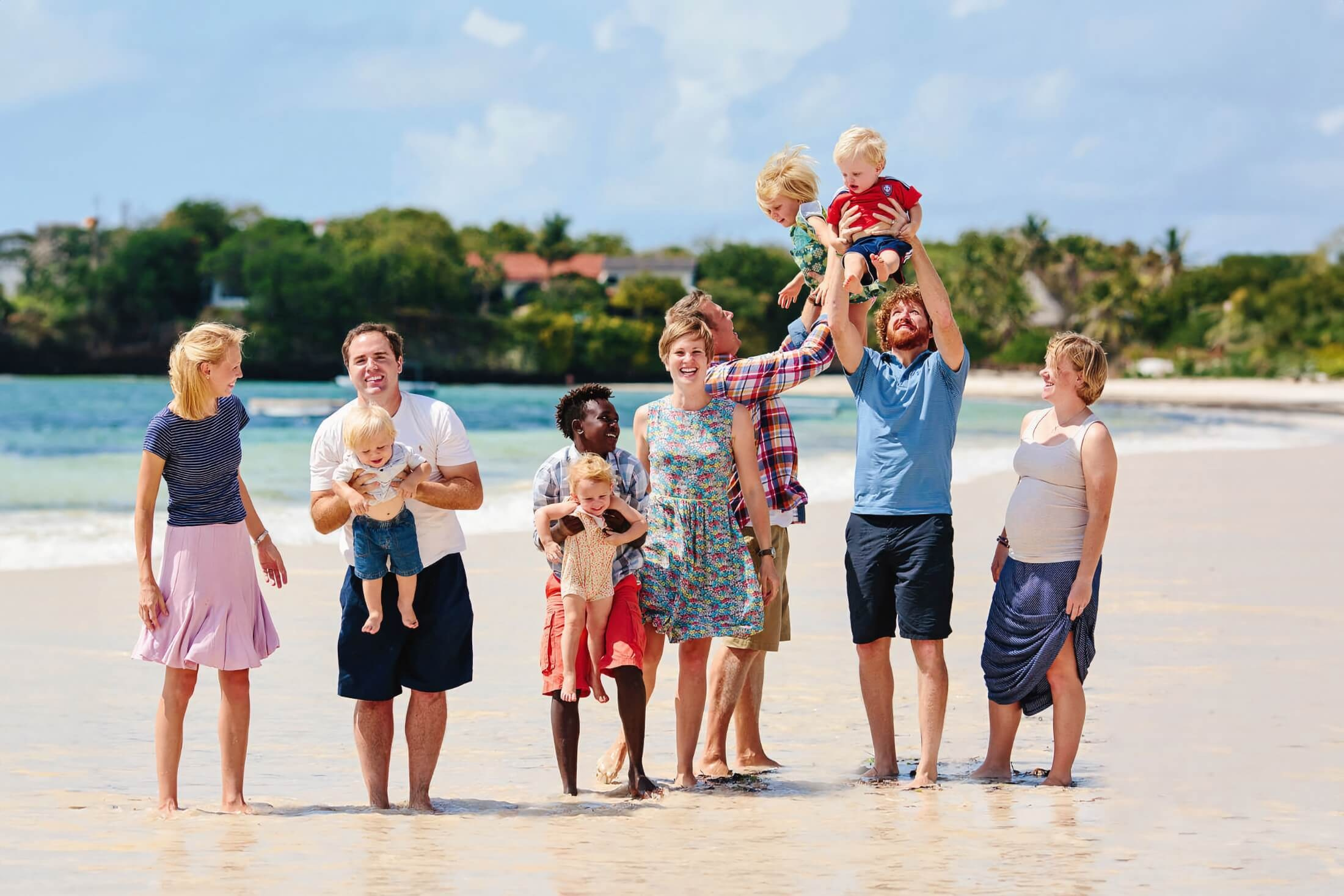 Families laughing together under the sun during a relaxed photo session on the beaches of Malindi and Watamu, Kenya—capturing joyful memories in natural light by Maiafreia.