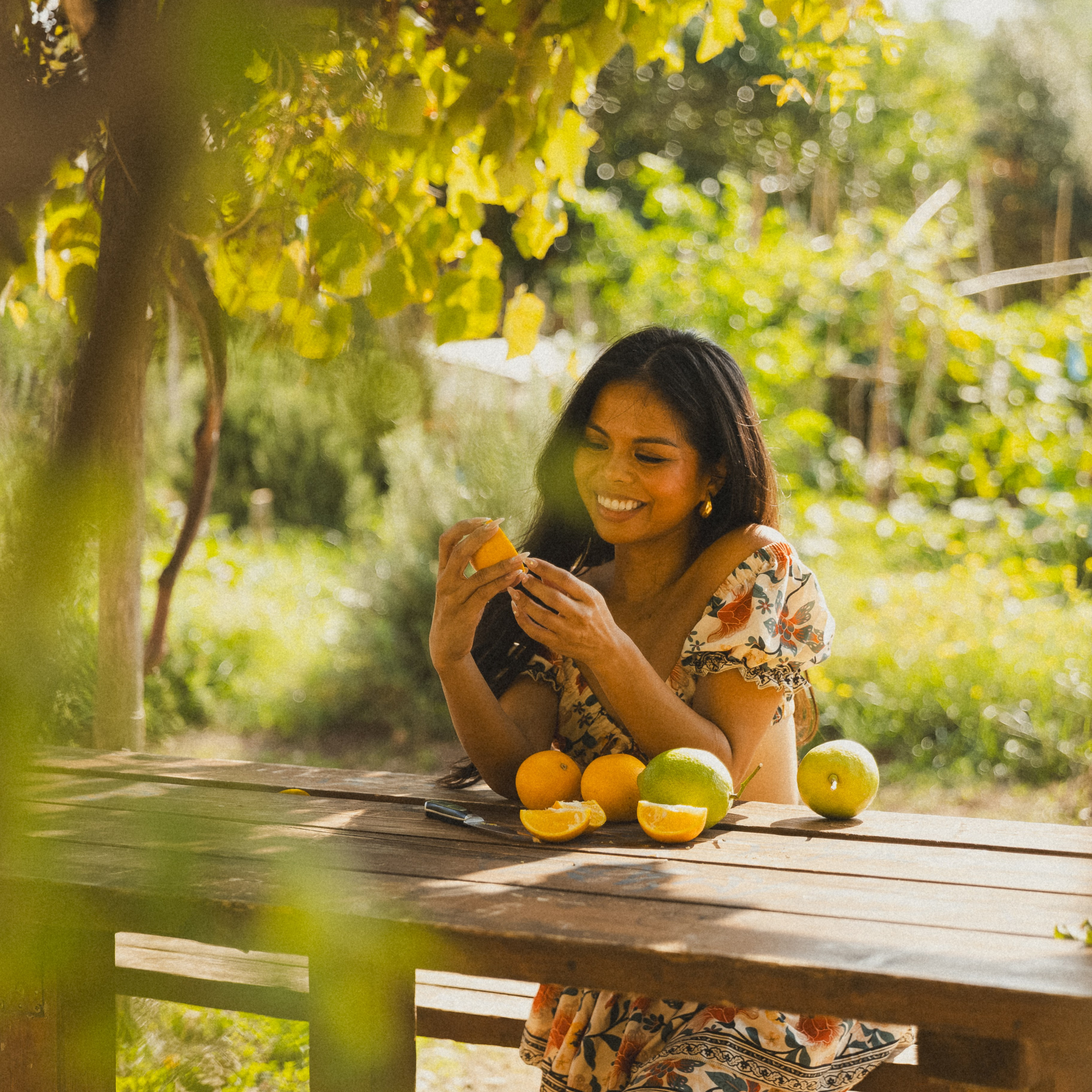 A stylish woman is in the Roman garden in a natural pose during a photoshoot.