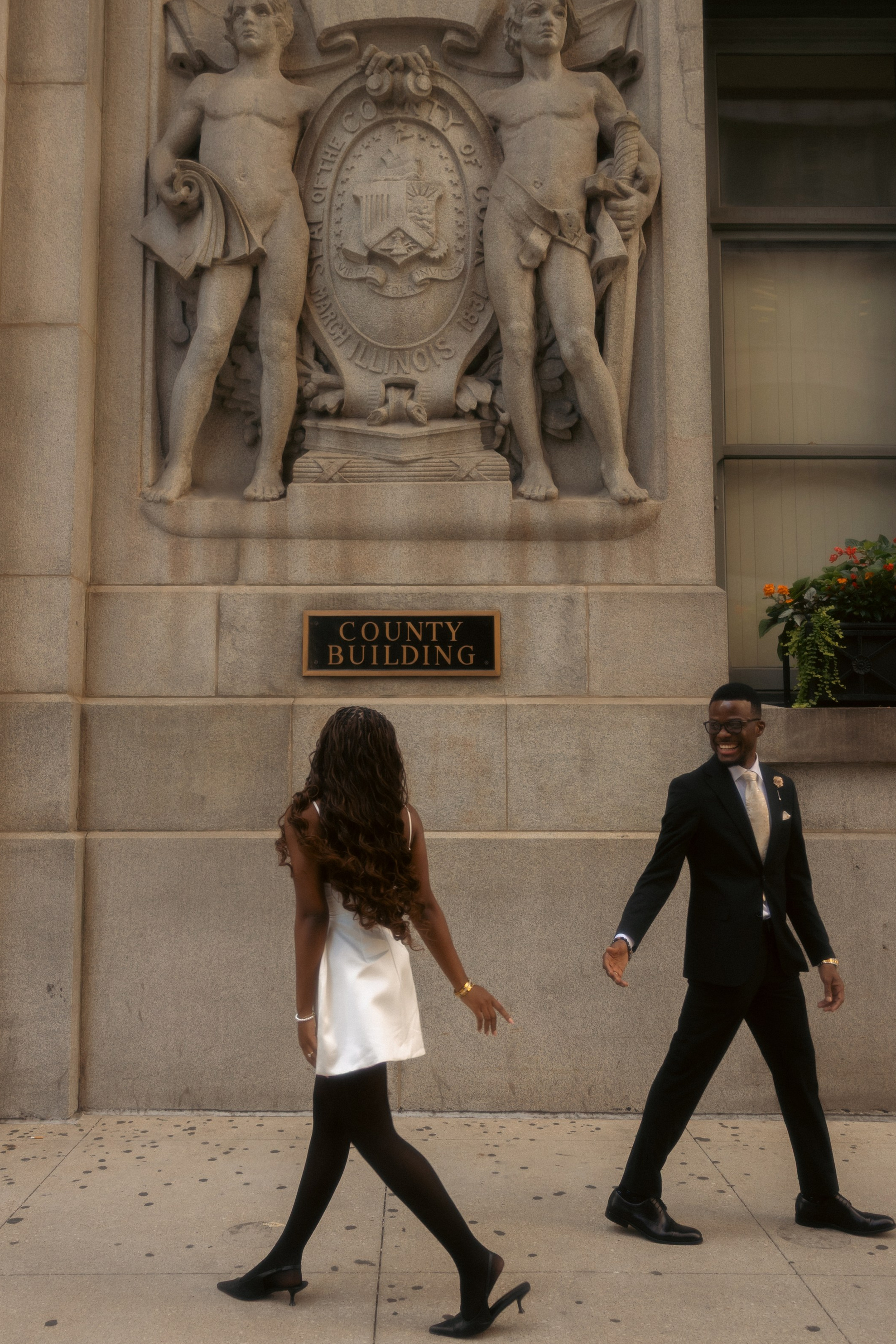 Bride walking down elegant staircase during intimate wedding in Chicago