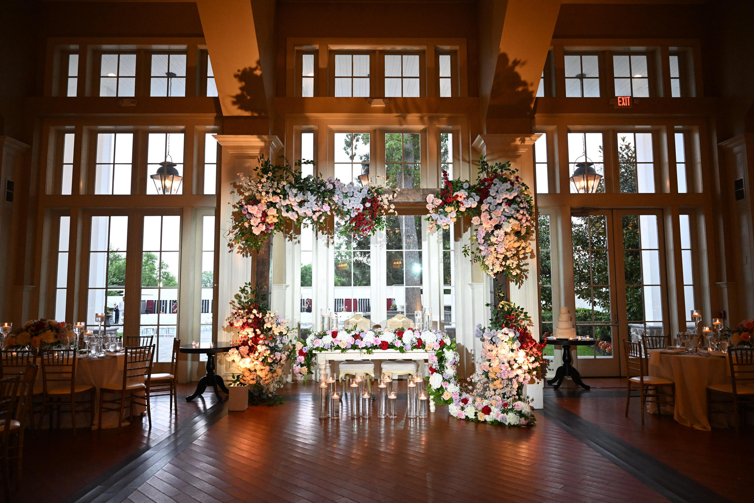 a wedding reception with a floral arch