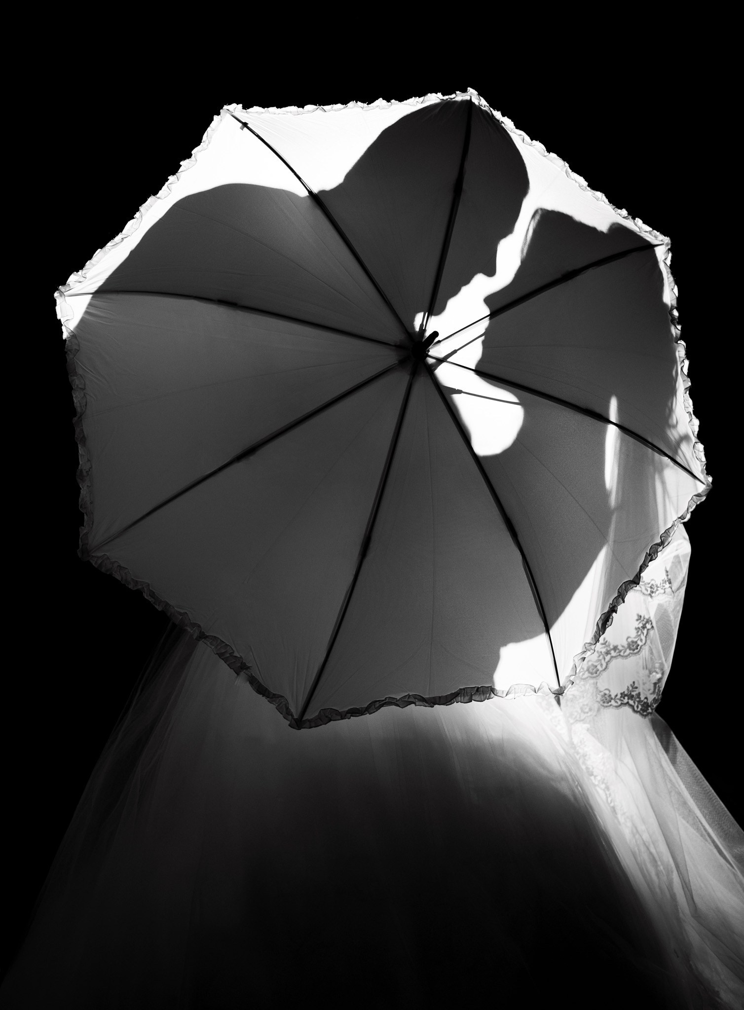 тіні молодят на парасольці