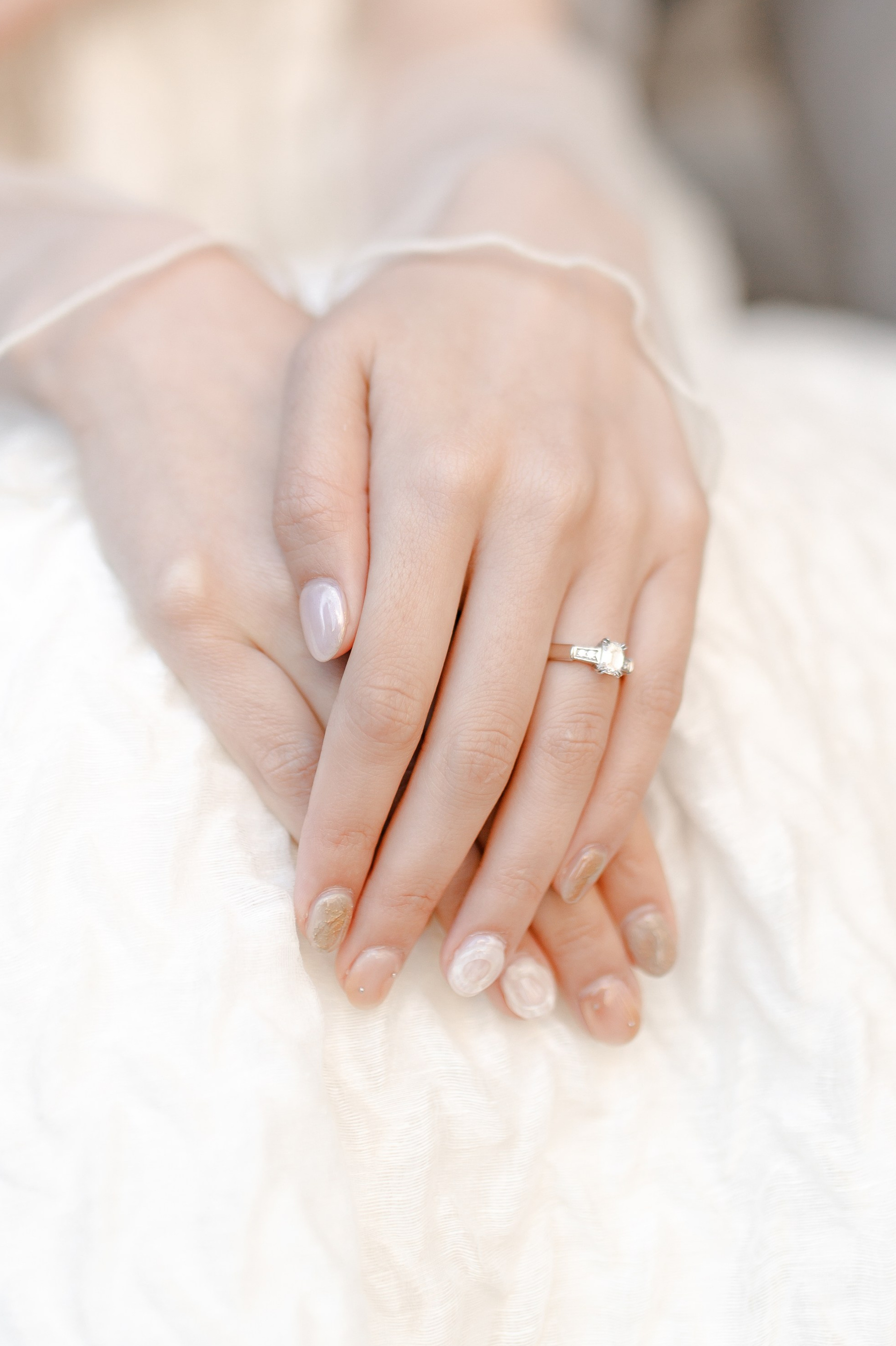 The bride's hands with the engagement ring 