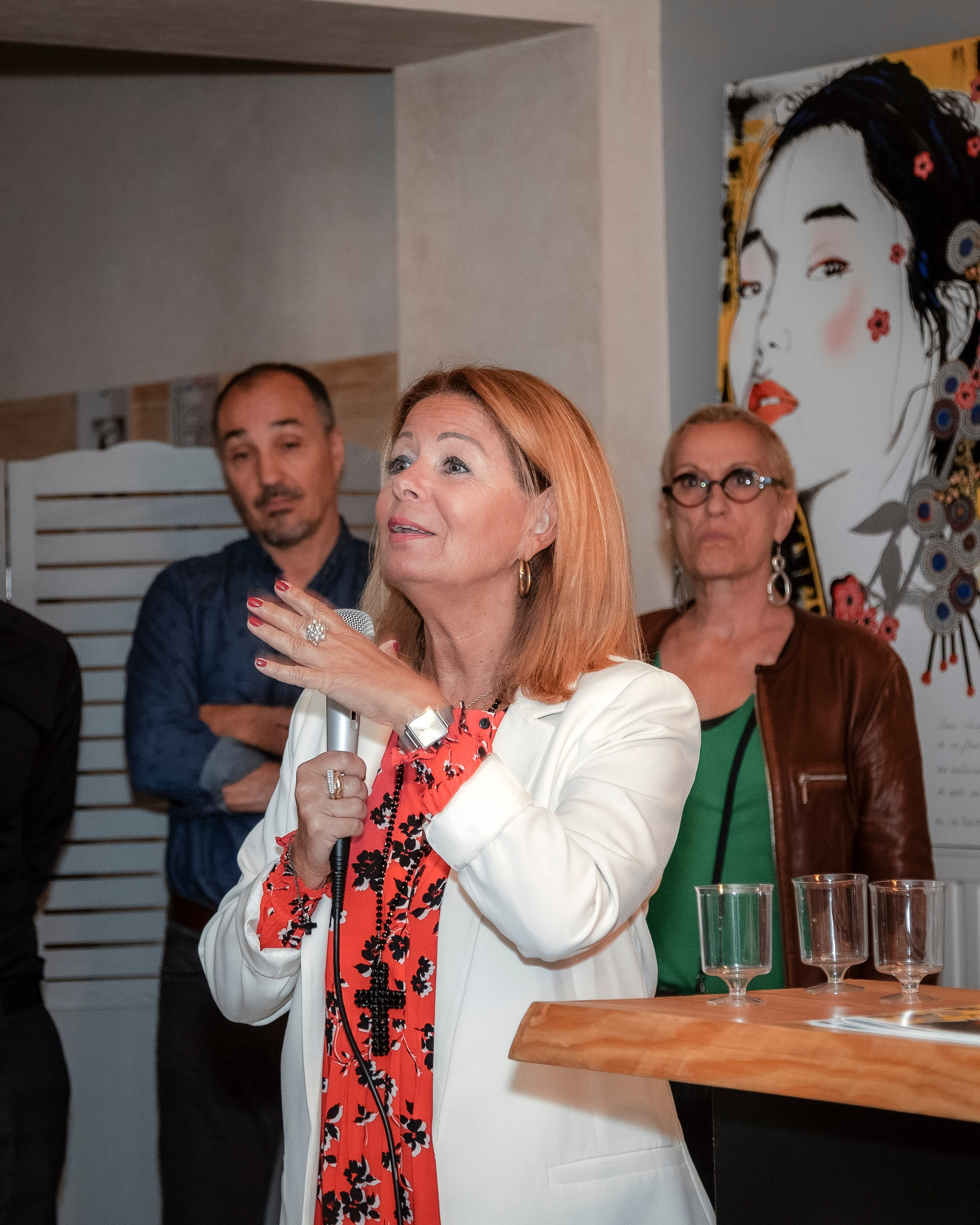 woman speaking to a small group during a corporate event