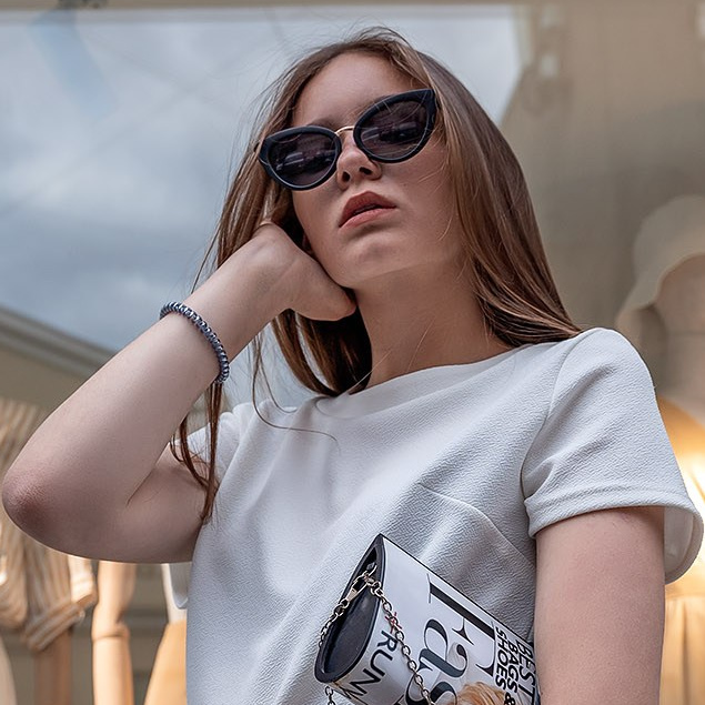 Outdoor photoshoot of a woman in front of a clothing store window in NJ