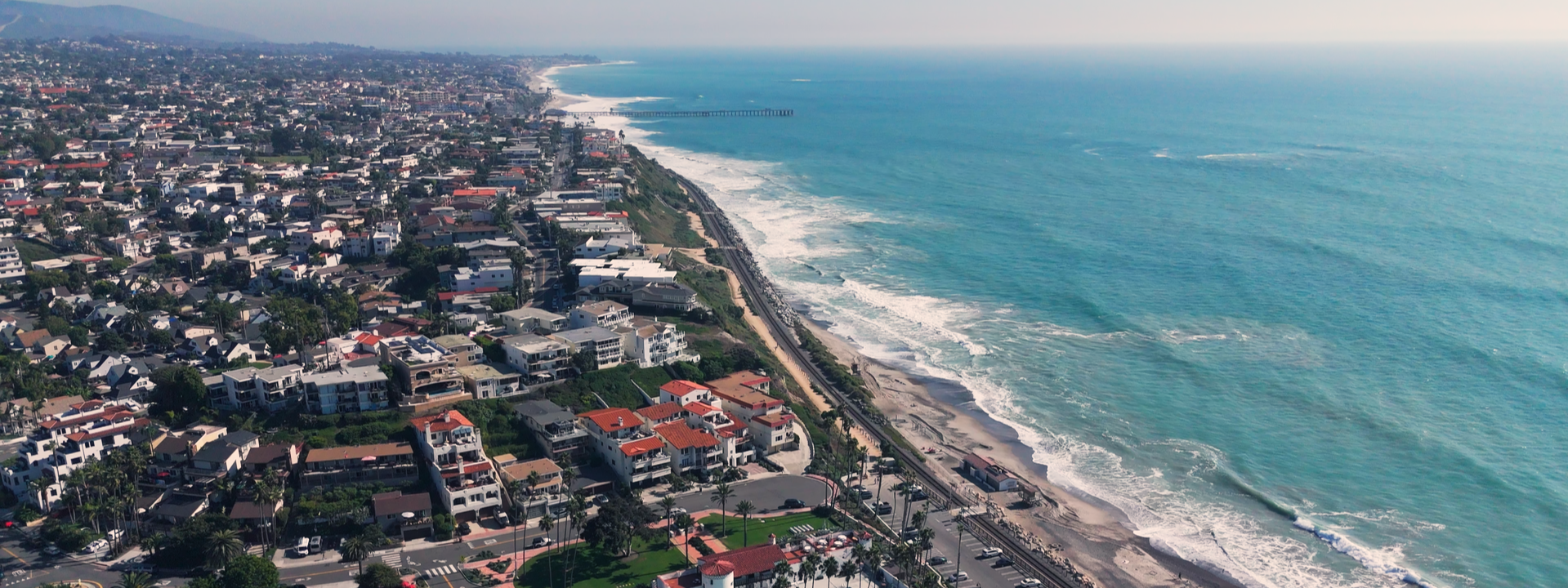 Coastal view of Los Angeles with a sandy beach and the Pacific Ocean, a favorite spot for photographers and video creators.
