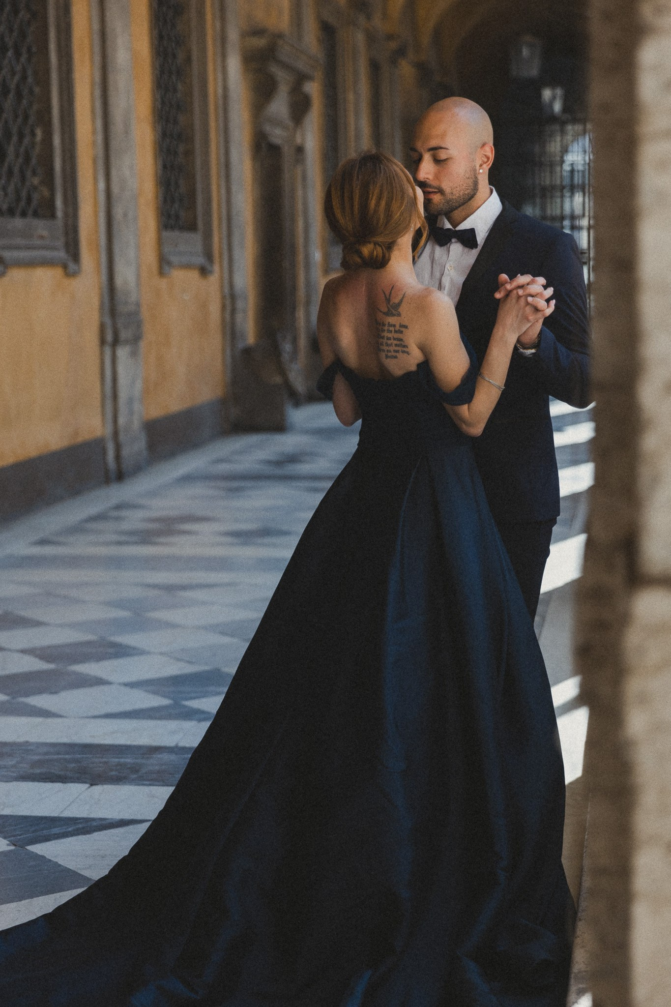 Elopment photography in Rome, a bride and groom share a tender moment beneath the archway of a picturesque villa in Rome, radiating timeless romance.