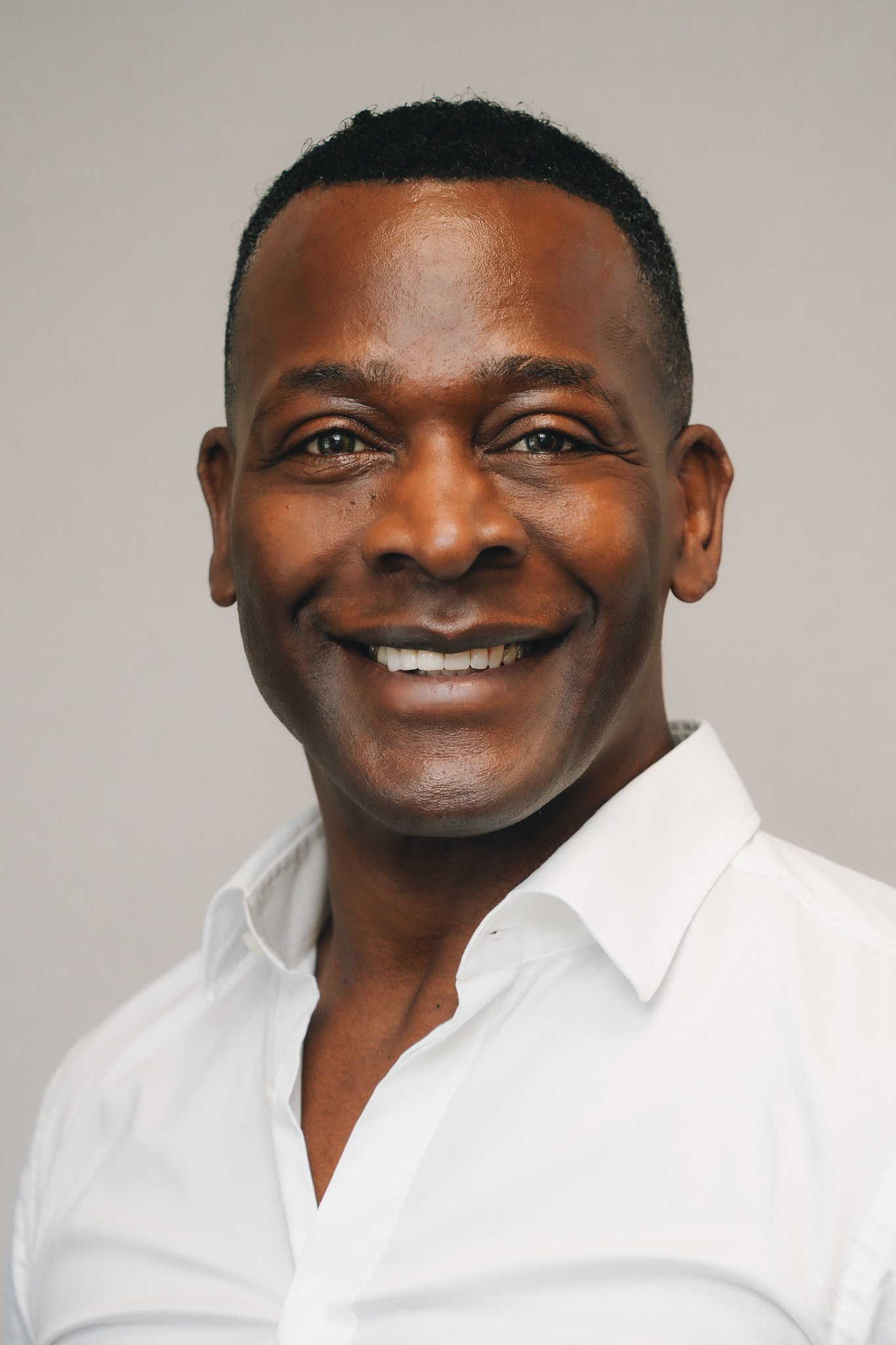 Clean professional headshot of a man with neutral background, suitable for business